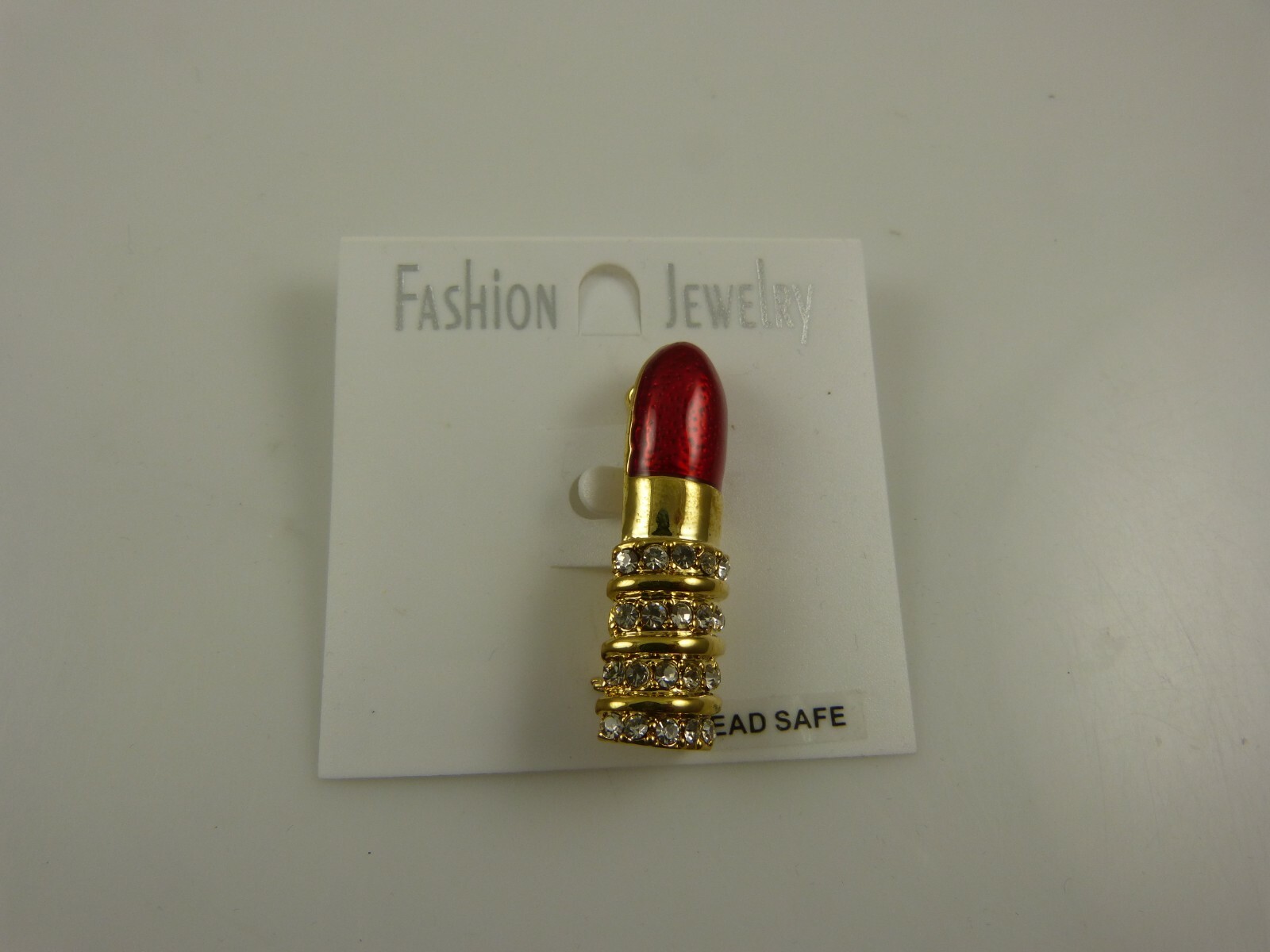 red lipstick pin bling crystals lead safe reds and gold avon mary kay reps