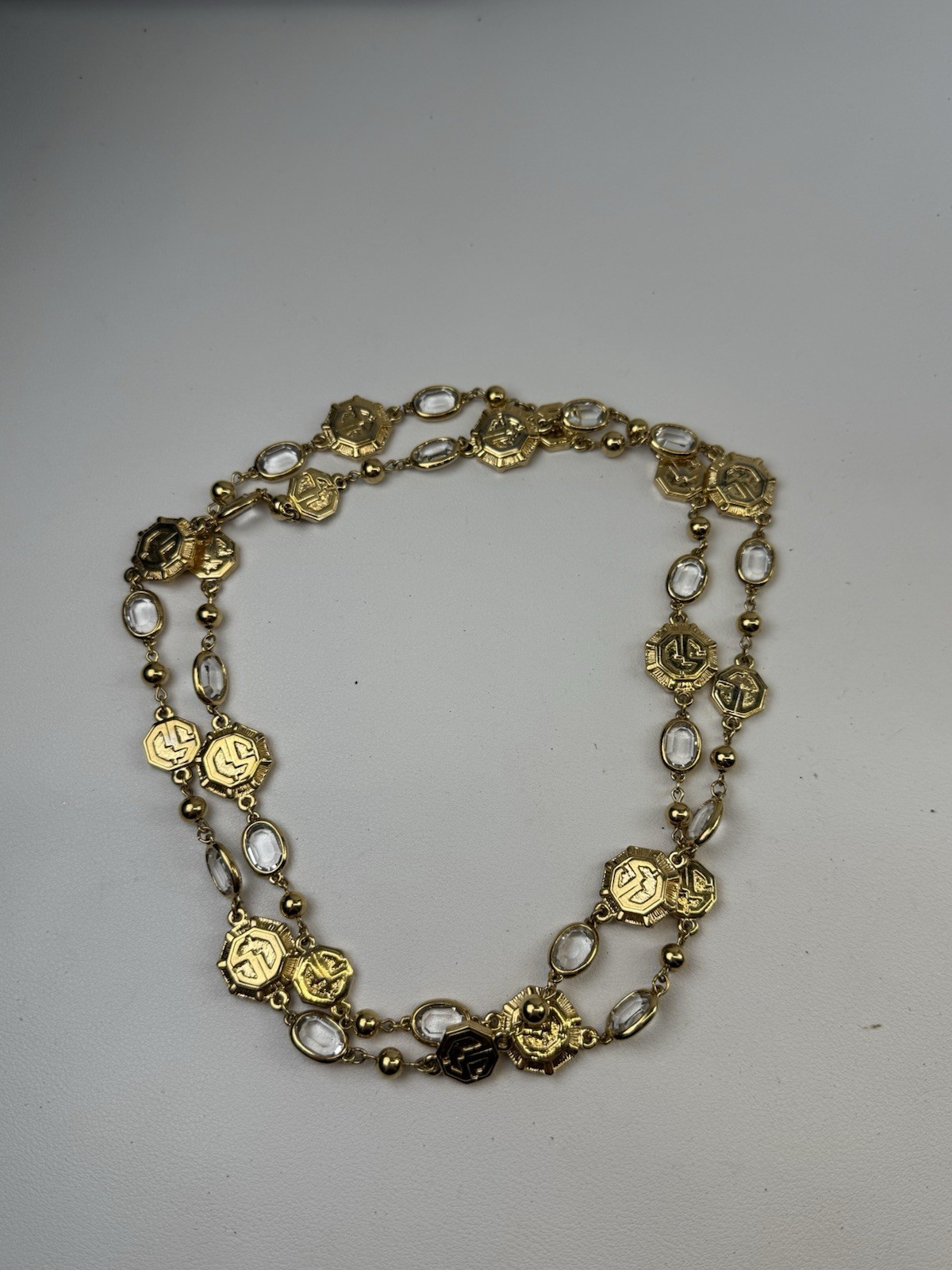 St. John Vintage 38″ Long Gold Tone Logo Necklace Clear Bezel Stations