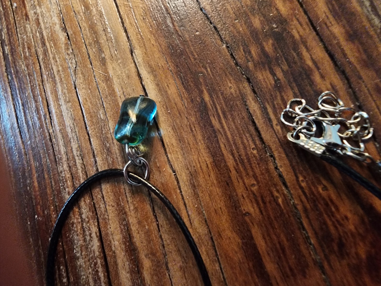 Handmade Black Corded Necklace with Clear Blue Glass Bead and black stripe
