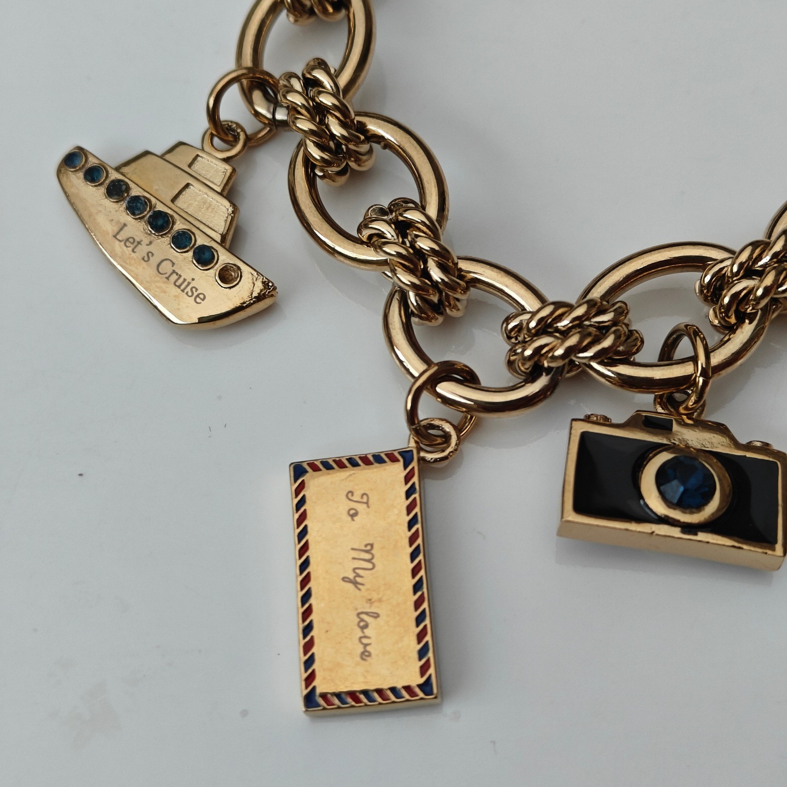 Anne Klein Womens Gold Tone Travel Charm Bracelet Watch World Map Airplane Bus