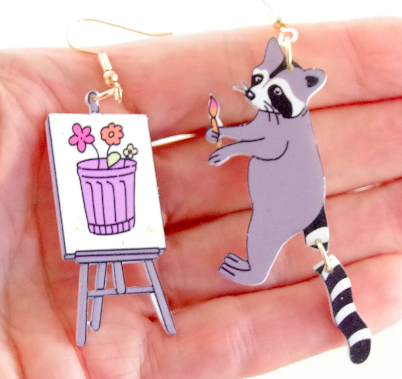 ASYMMETRICAL RACOON ARTIST PAINTING FLOWERS IN GARBAGE CAN ACRYLIC DROP EARRINGS