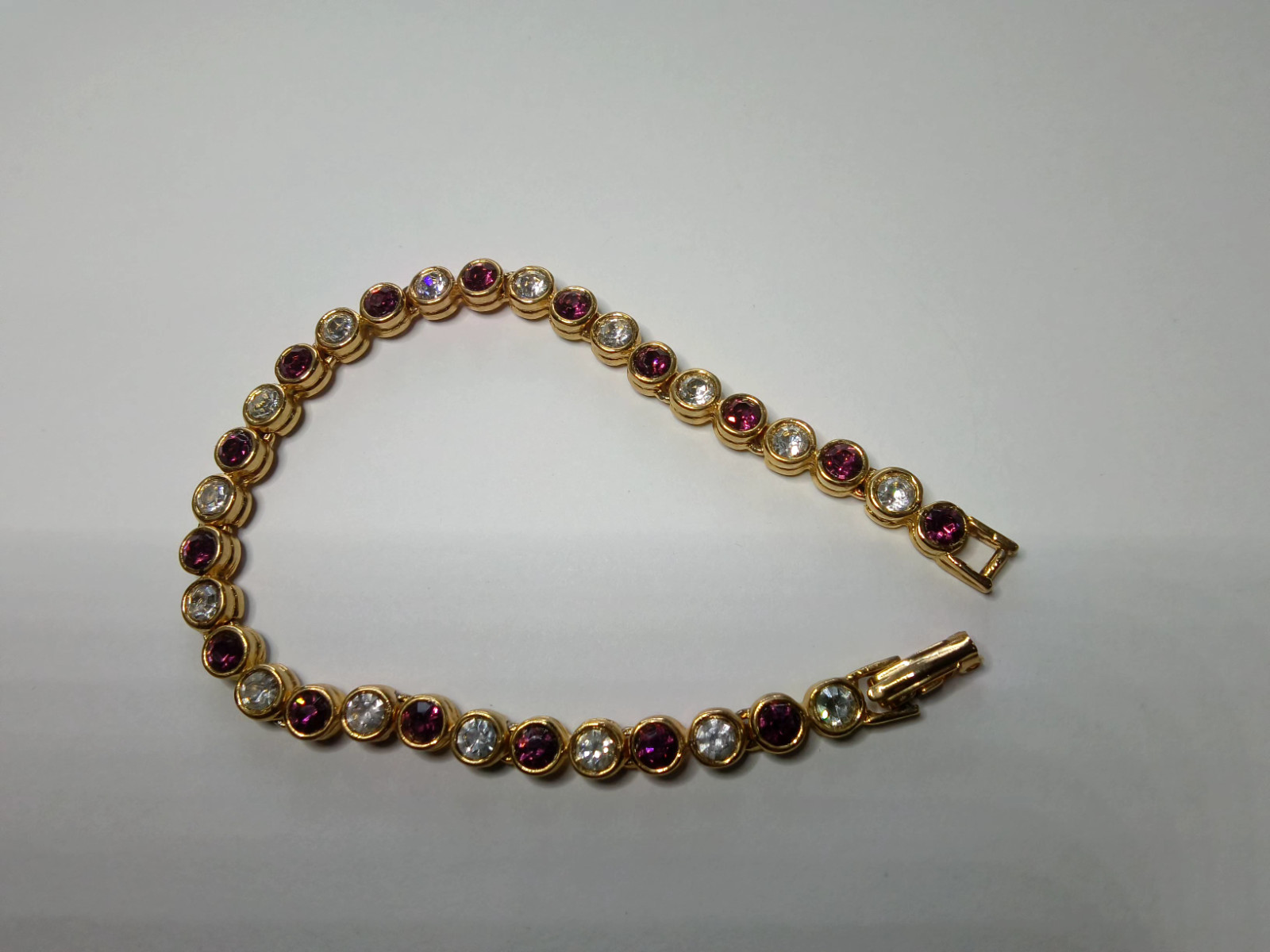 Gold Tone Tennis Bracelet with Alternating Clear and Purple Rhinestoness