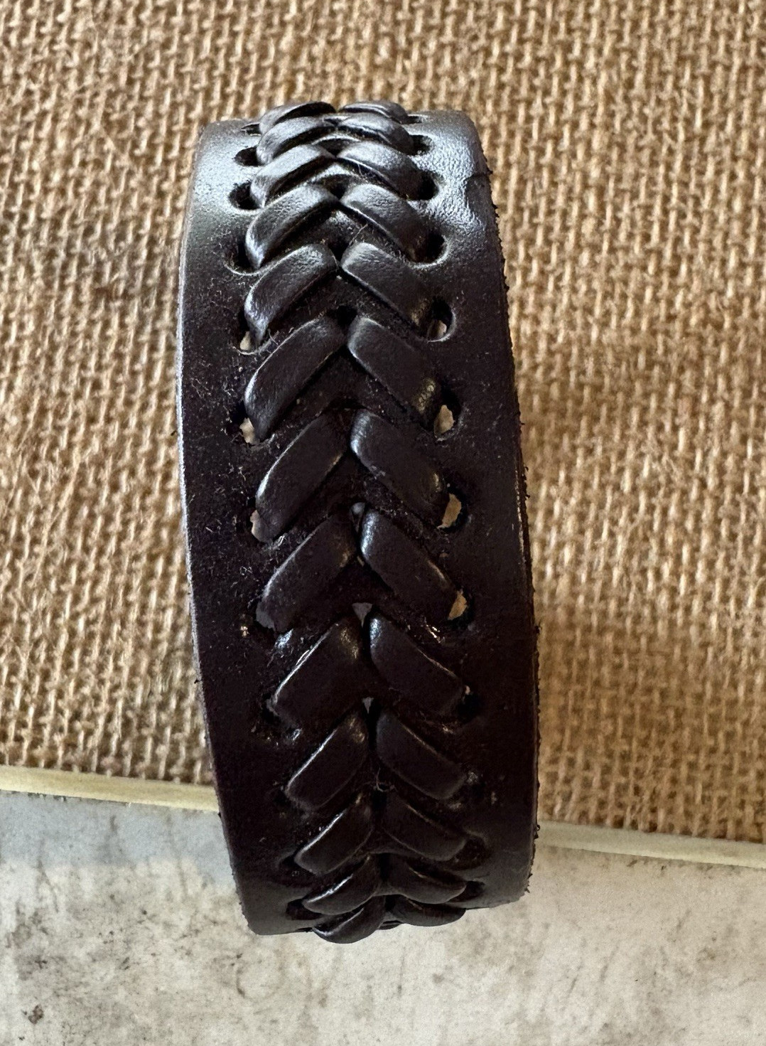 brown braided leather cuff bracelet . adjustable 8 in . snap closure . no stone