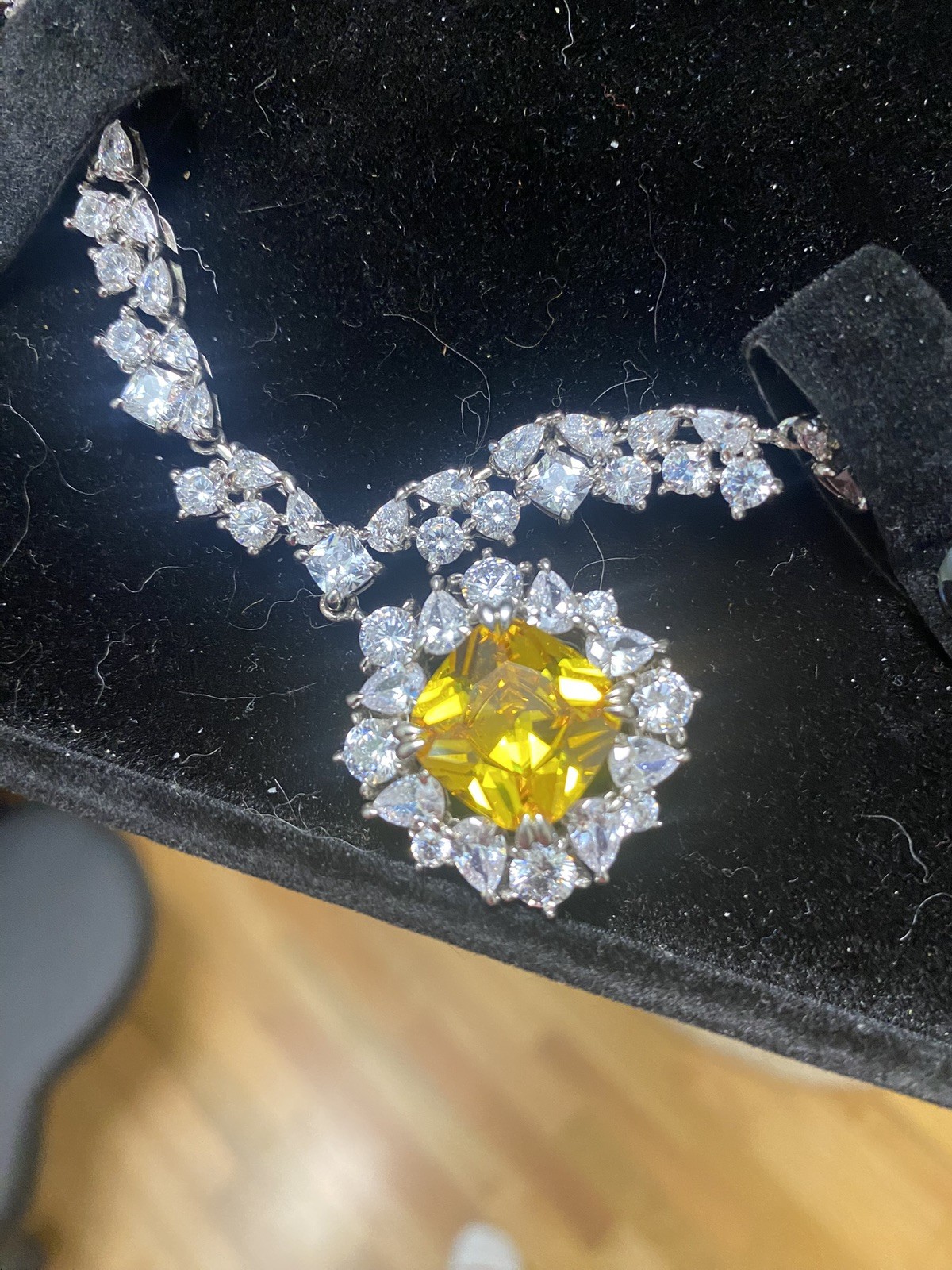 Golden Pendant necklace w/ man made diamonds surroundings the chain & pendant
