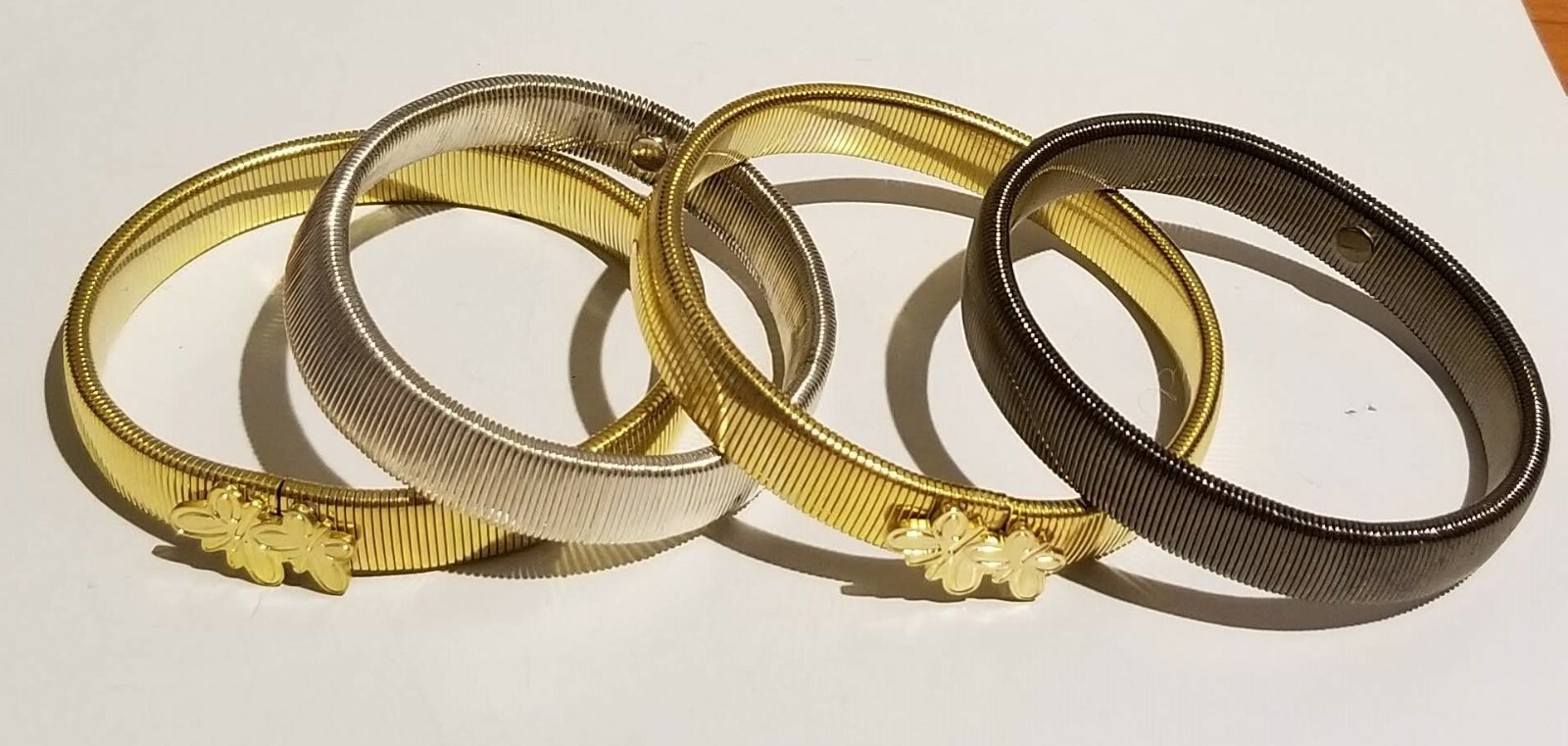**Banglemania 4 Flexible Bracelets 2 Gold Tone 1 Silver 1 Gun Metal**