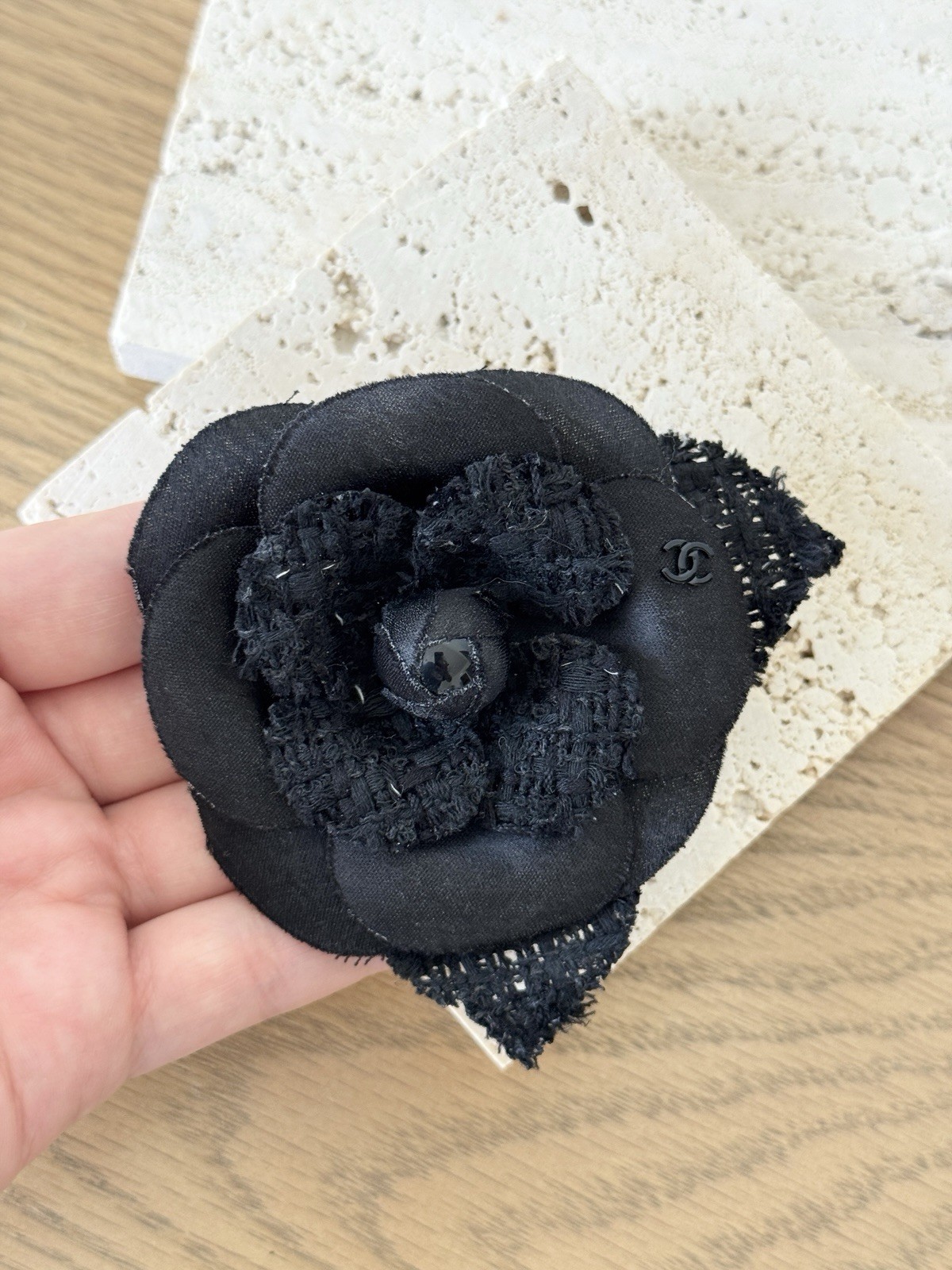 CHANEL Camélia Brooch crafted from black tweed/canvas