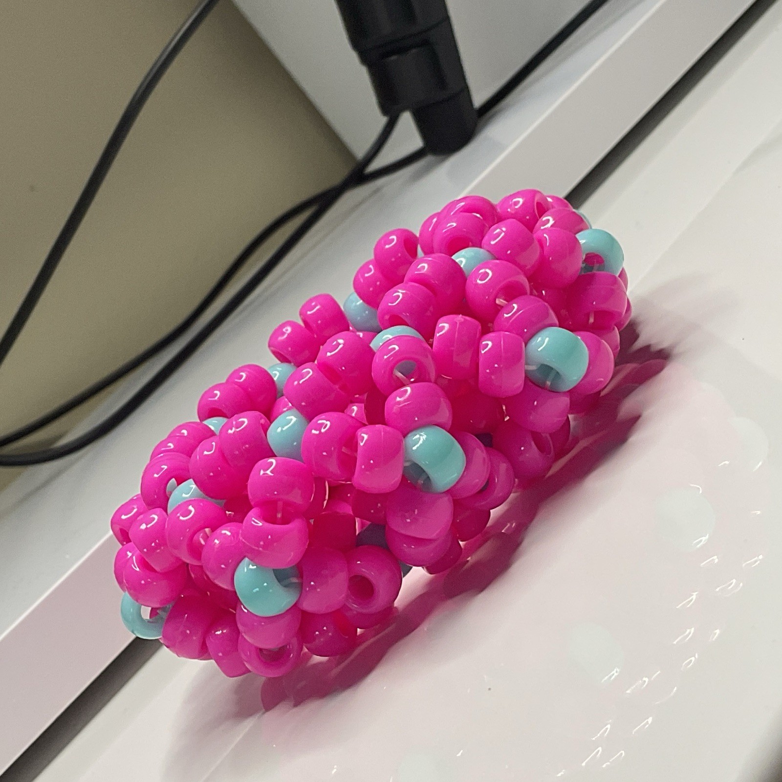 handmade pink w/ cyan accents 3d X’s kandi cuff 😋😋😋 has SUPER stretchy string