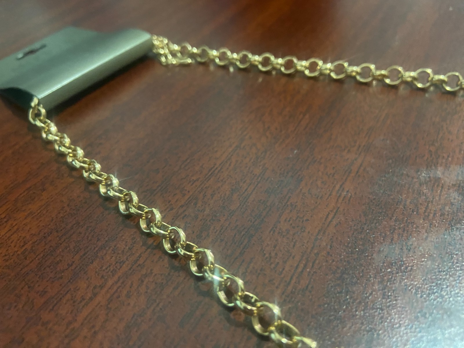 Gold chained necklace with cyan, white and oak brown gemstones.