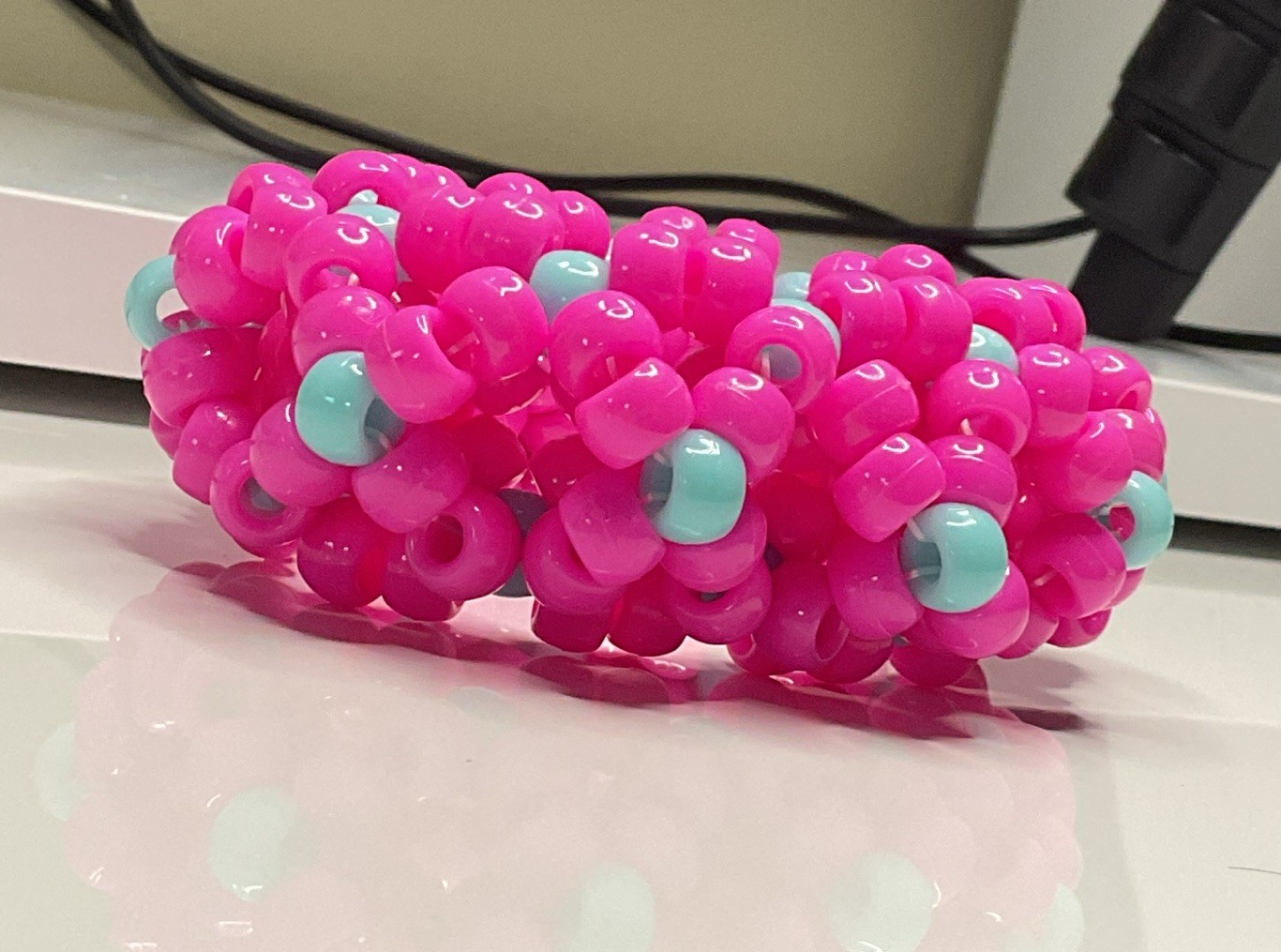 handmade pink w/ cyan accents 3d X’s kandi cuff 😋😋😋 has SUPER stretchy string