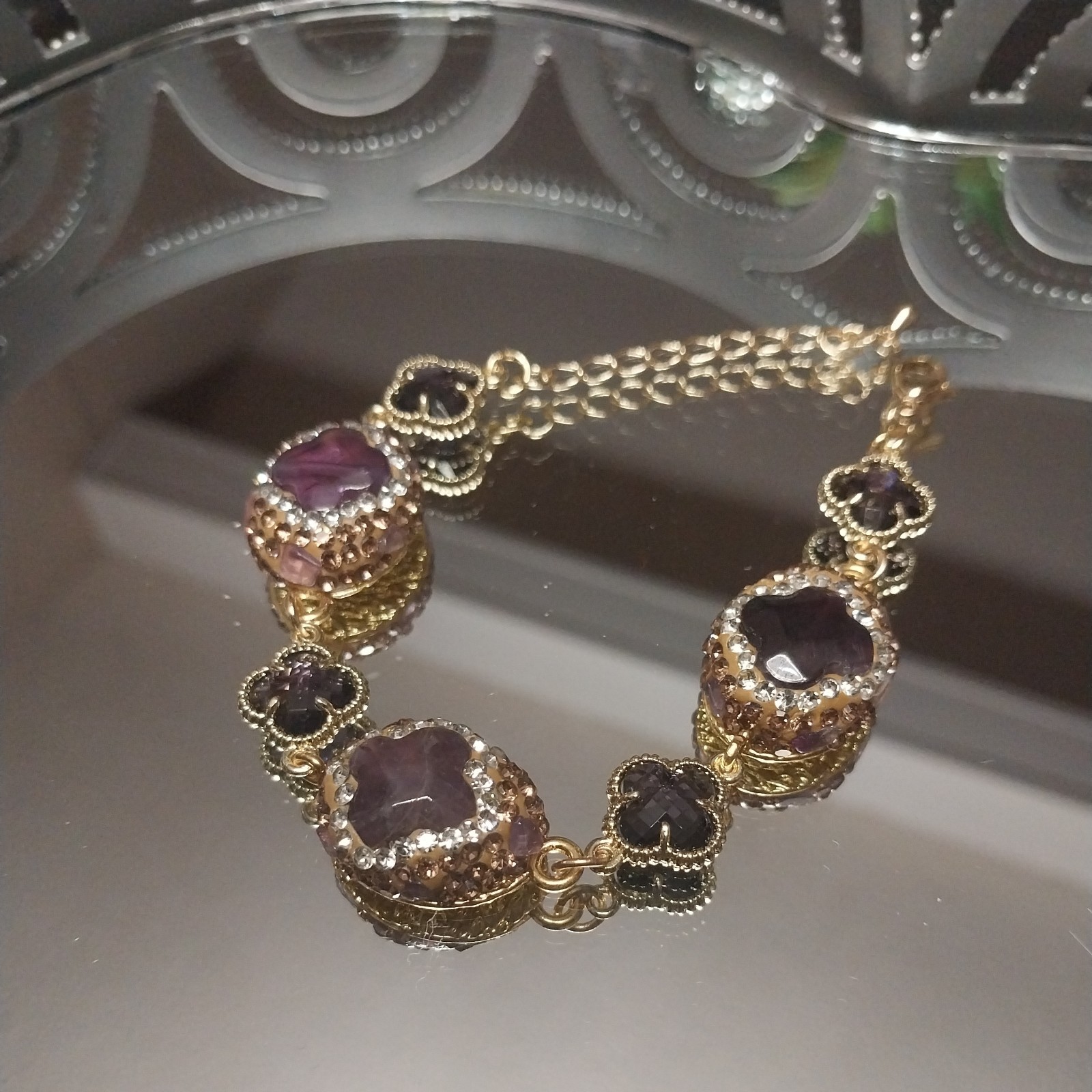 Gold Plated bracelet with purple amethysts and sparkling clover-shaped crystals.
