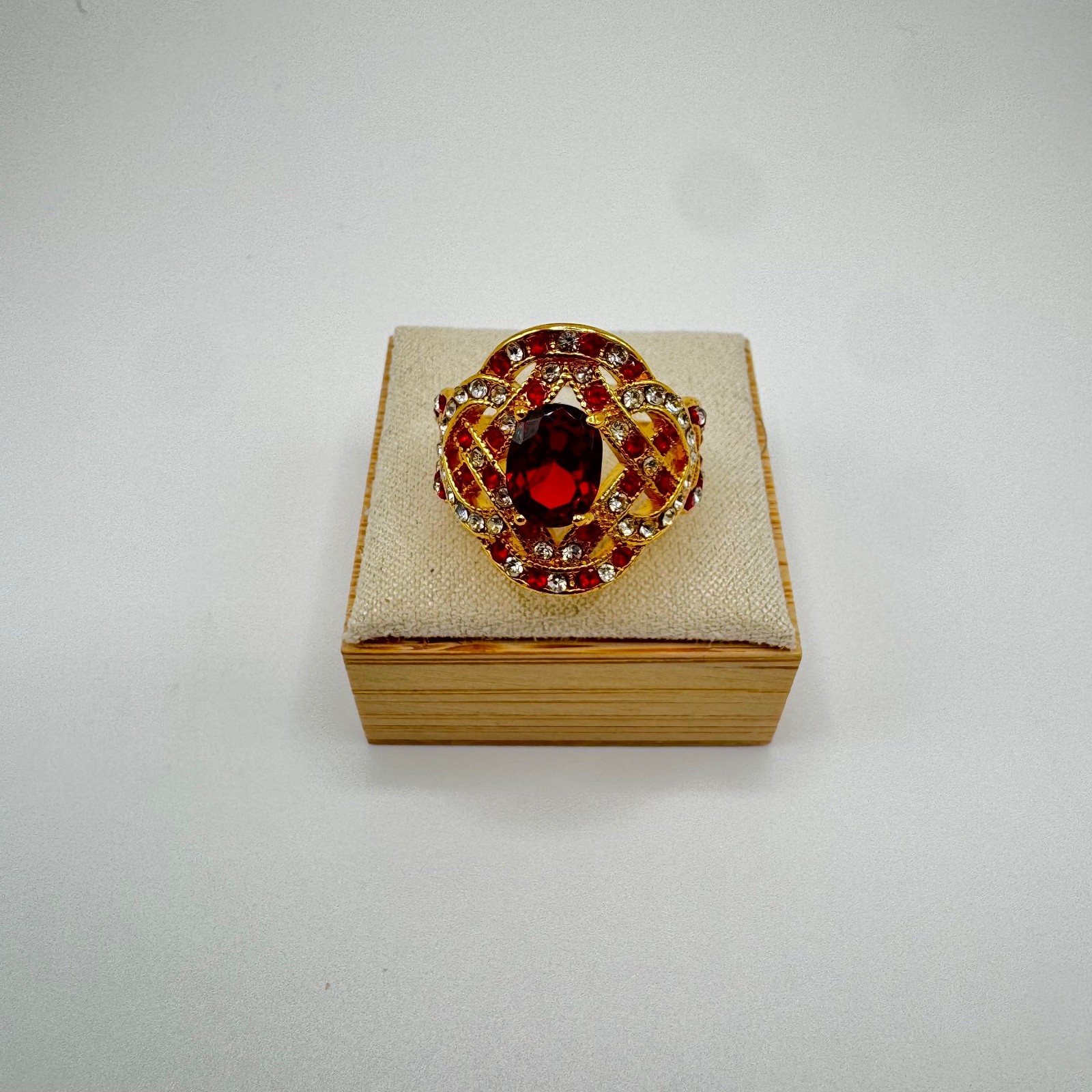 Gold tone statement ring bundle with one central stone and ornate accent stones