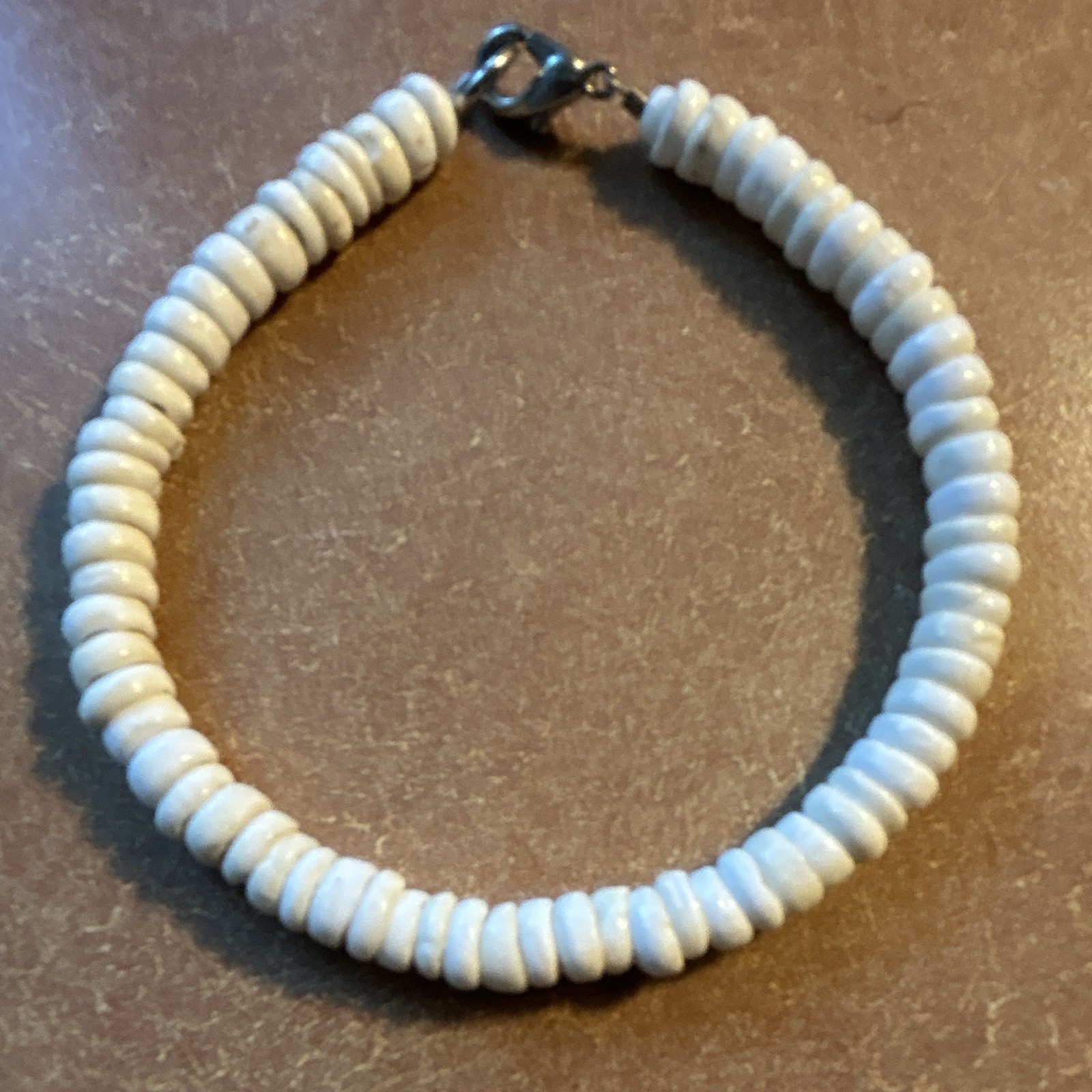 Vintage white puka shell heishe bead, lobster clasp. Length 8 1/2”