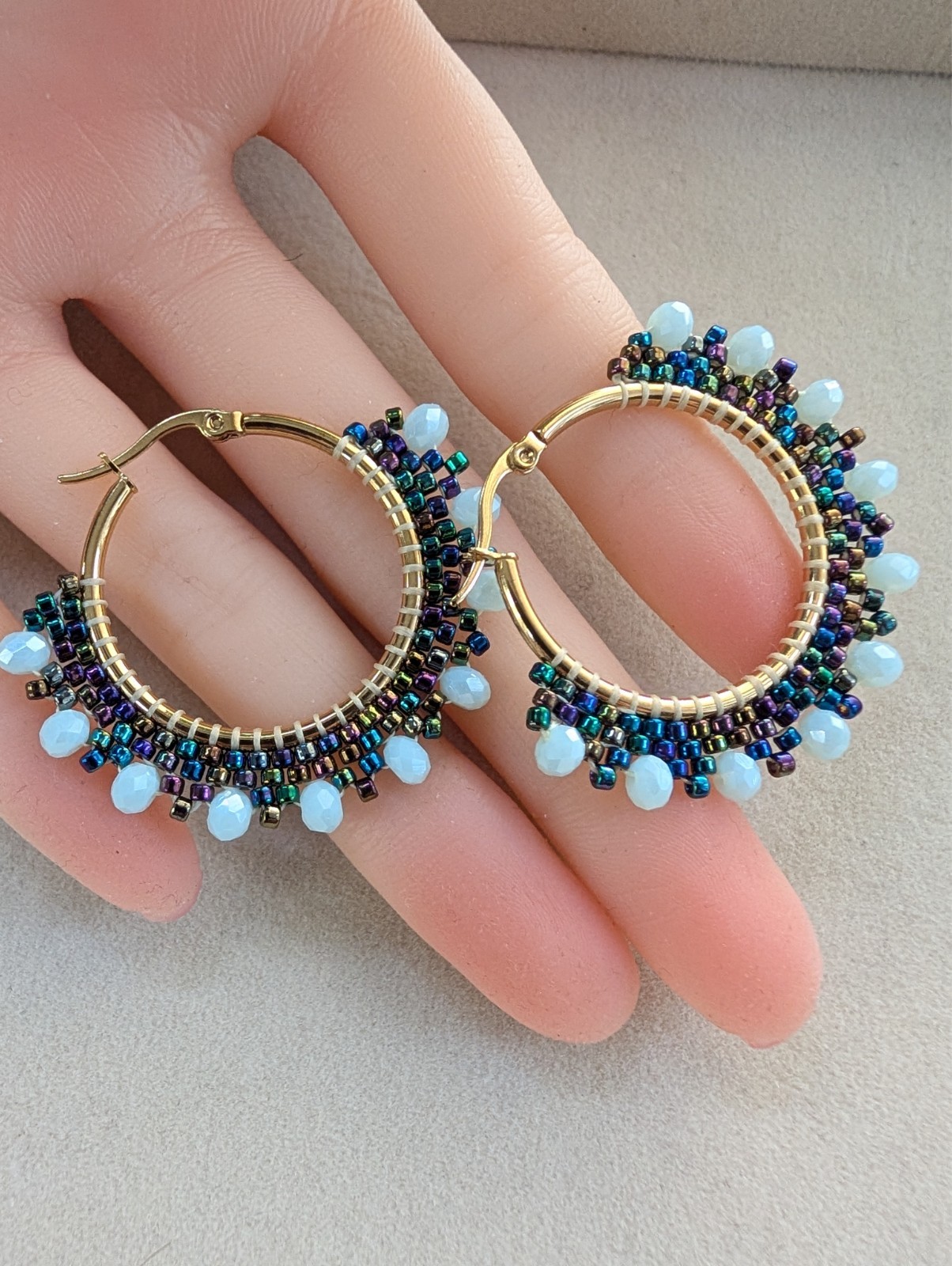 Hoop circle earrings with black peacock seed beads and blue beads