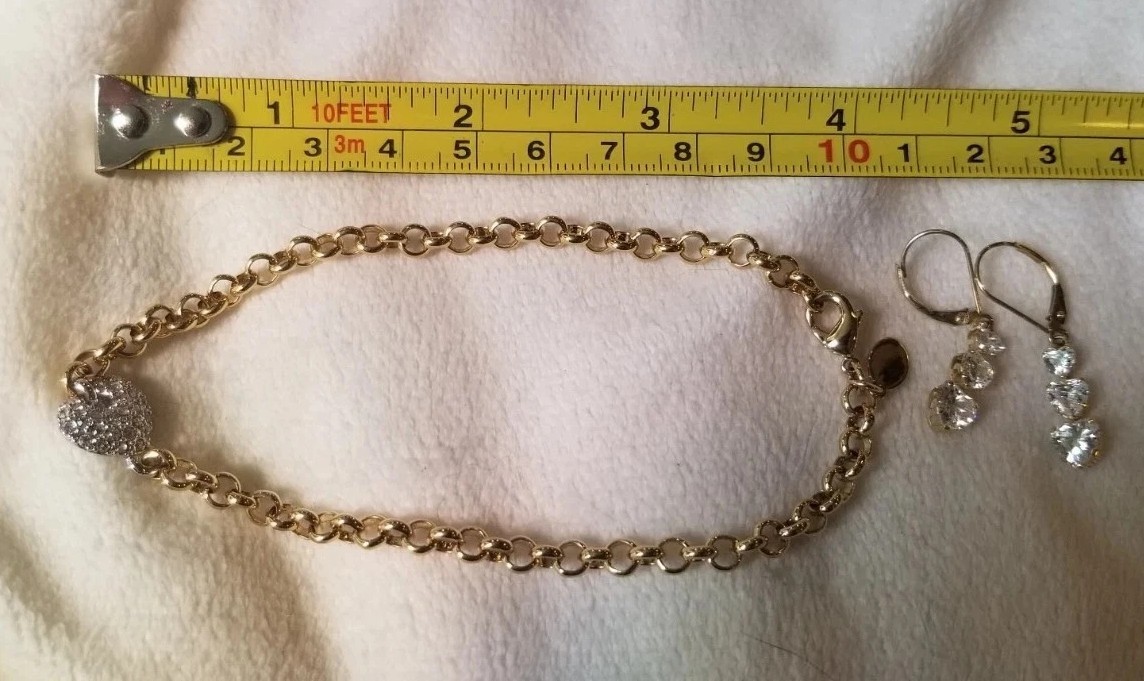 Costume jewelry matching bracelet earrings gold tone band silver heart accent