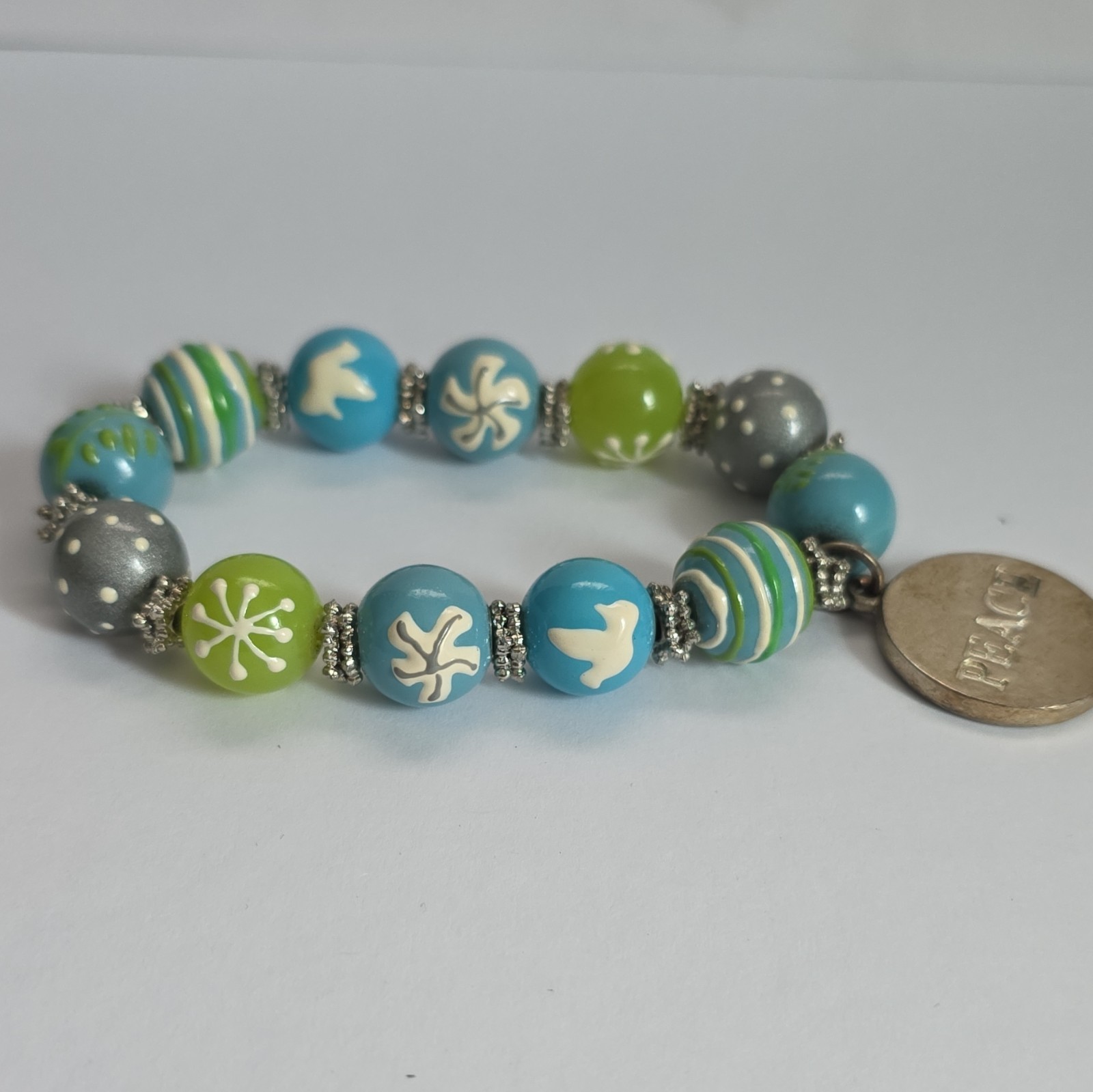 Vintage Angela Moore hand-painted beaded bracelet features blue, green, & gray