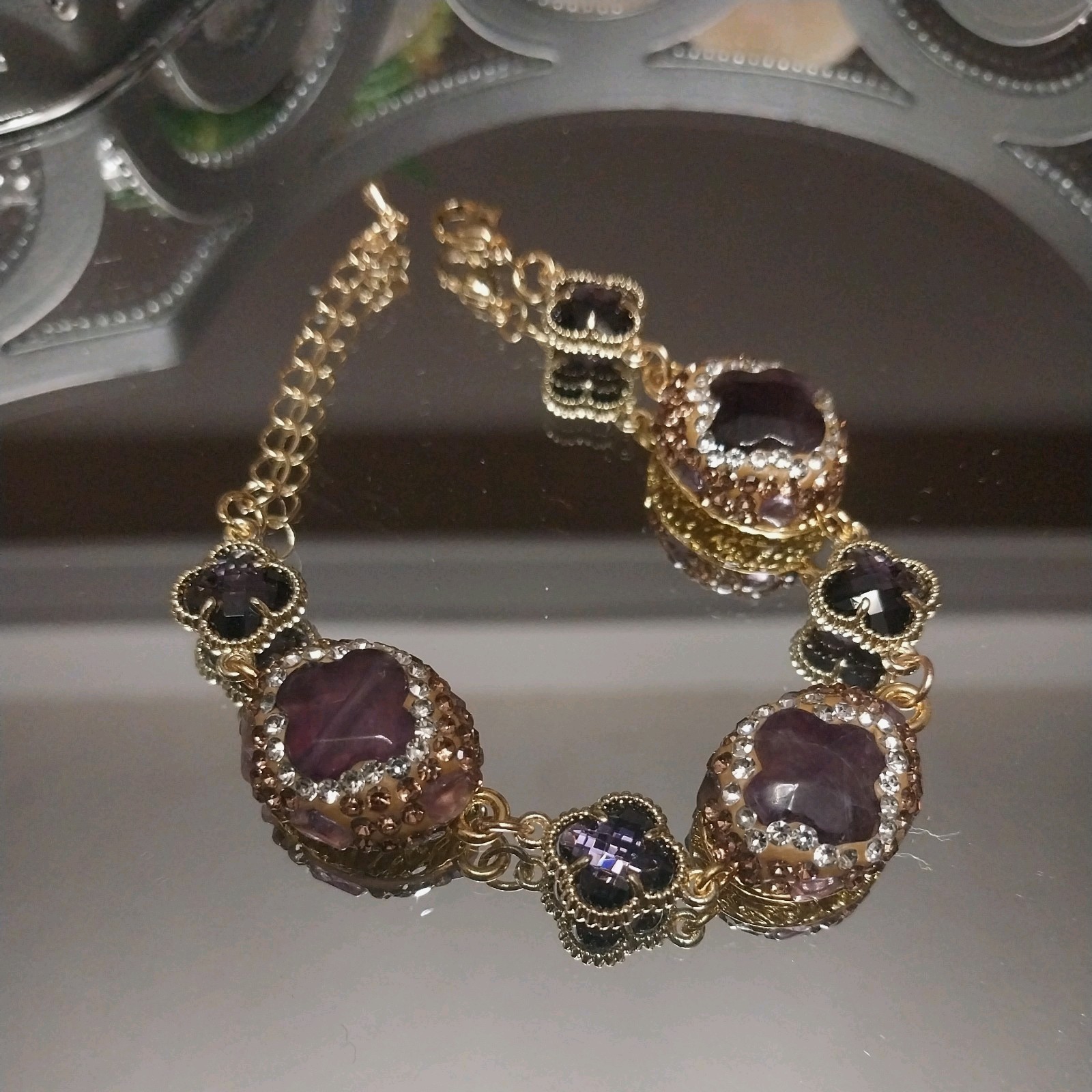Gold Plated bracelet with purple amethysts and sparkling clover-shaped crystals.