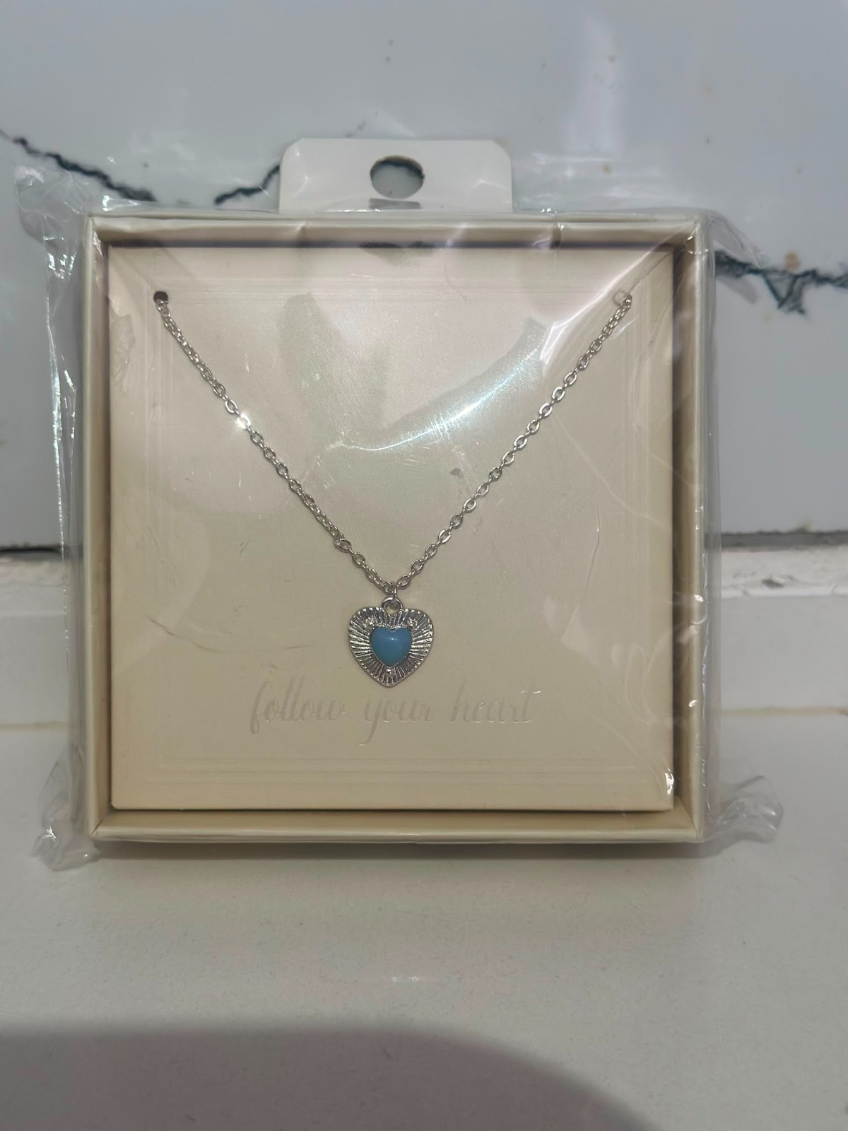 A smooth, rust-resistant silver chain featuring an elegant and attractive blue h