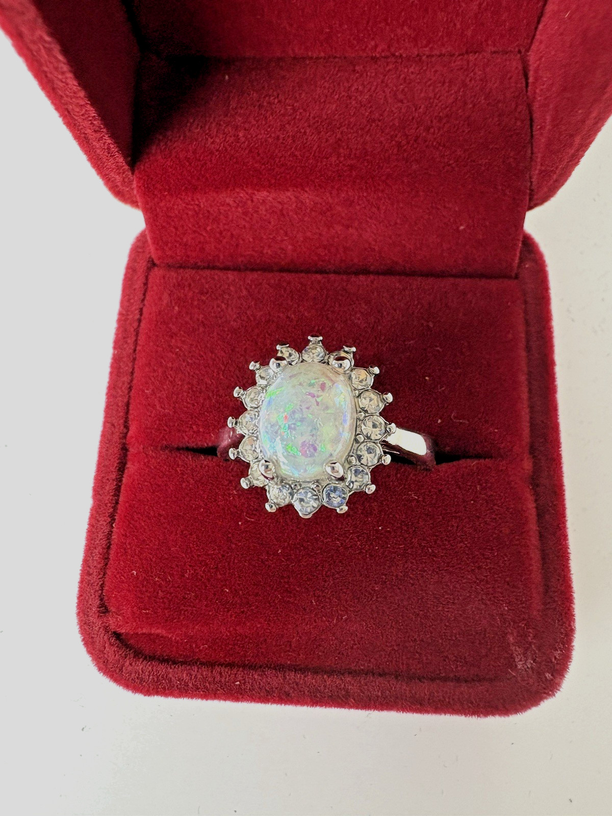 Silver Tone Ring with Opal Color Oval Cabochon Surrounded by White Rhinestones