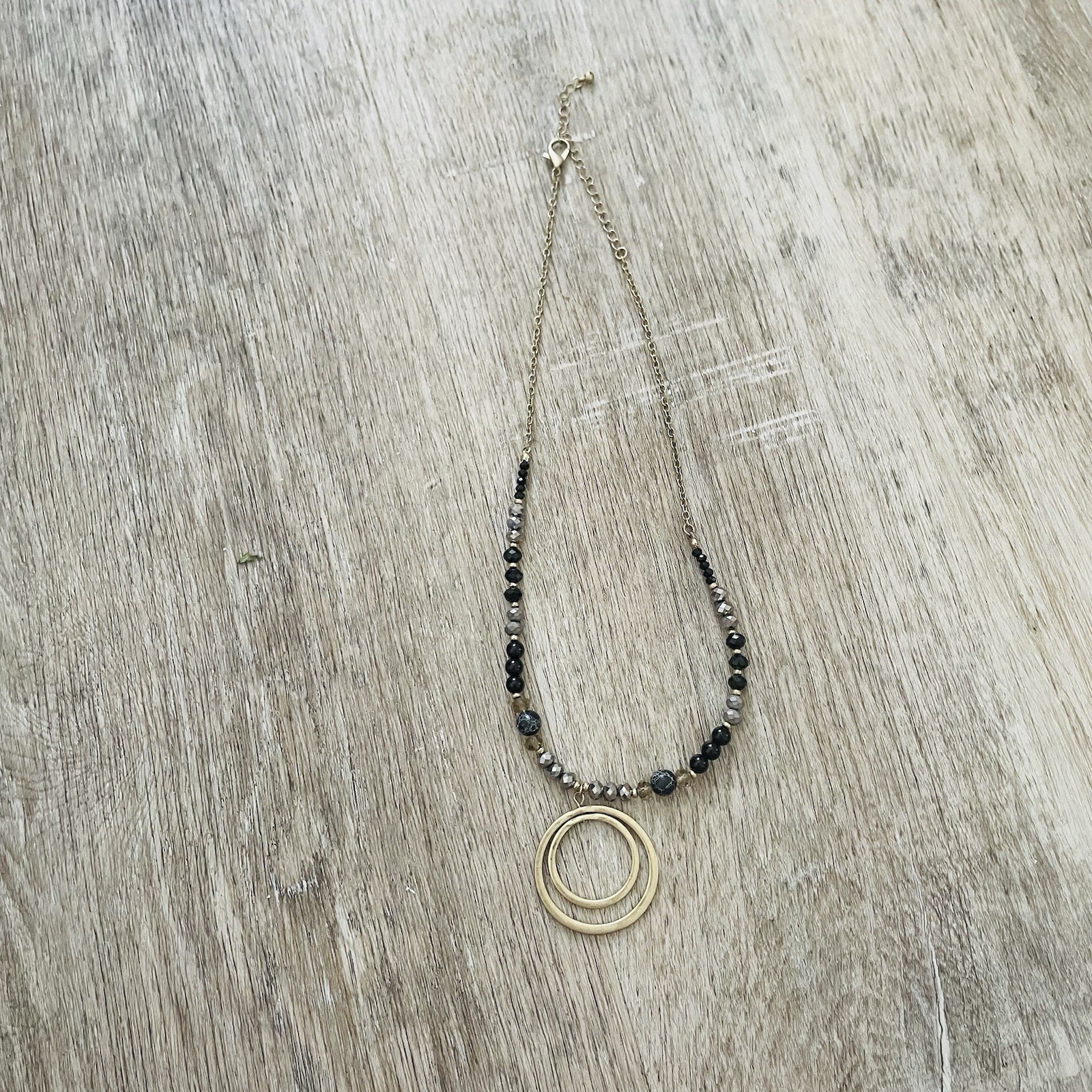 Gold Double Ring Pendant Necklace with Black and Gray Beads