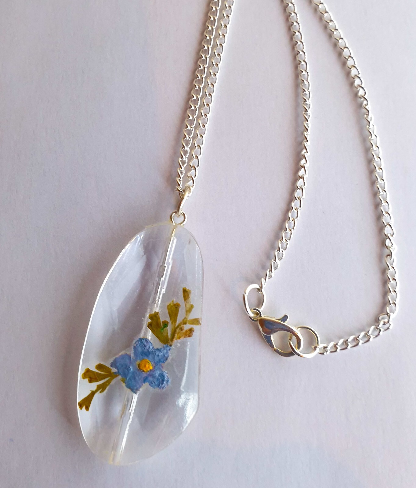 Handmade colour enhanced sealed pressed forget me not necklace, acrylic.