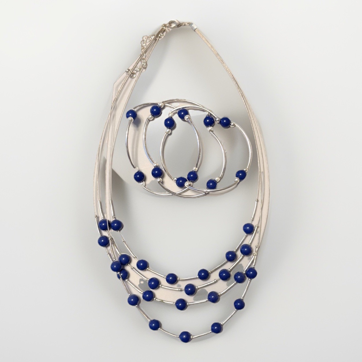SILVER-TONE MULTI-STRAND NECKLACE AND BRACELET WITH BLUE BEADS