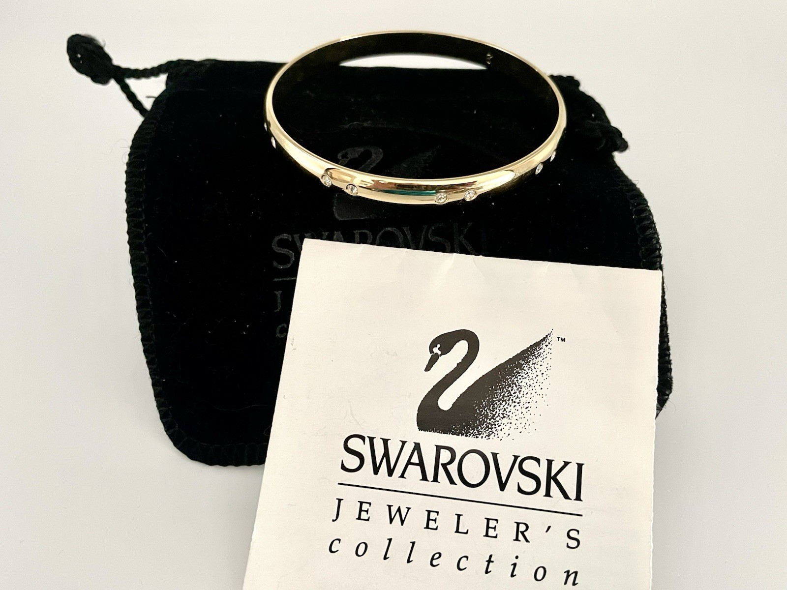 Swarovski Gold Tone Bangle Bracelet with Scattered Crystal Accents Swan Logo