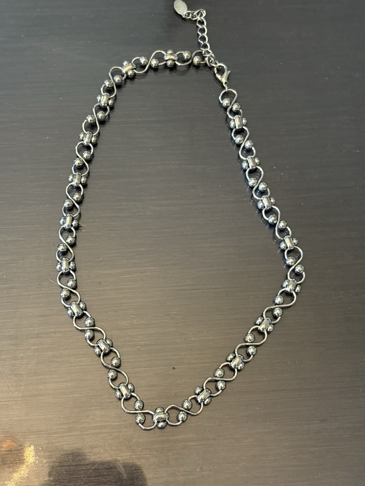 VTG Silver-tone mixed link chain necklace featuring intertwined infinity wave