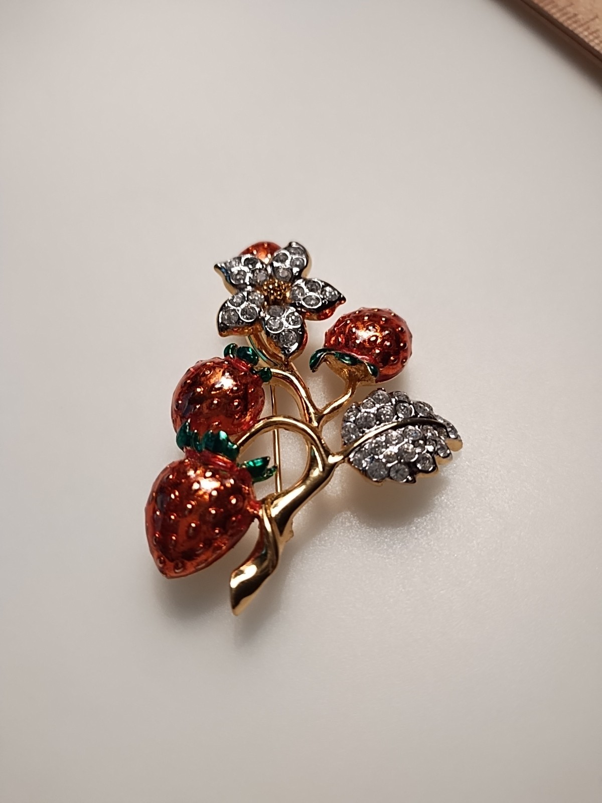 Gold Tone Strawberry broch with enamel strawberry and rhinestone Leafs 2 inch