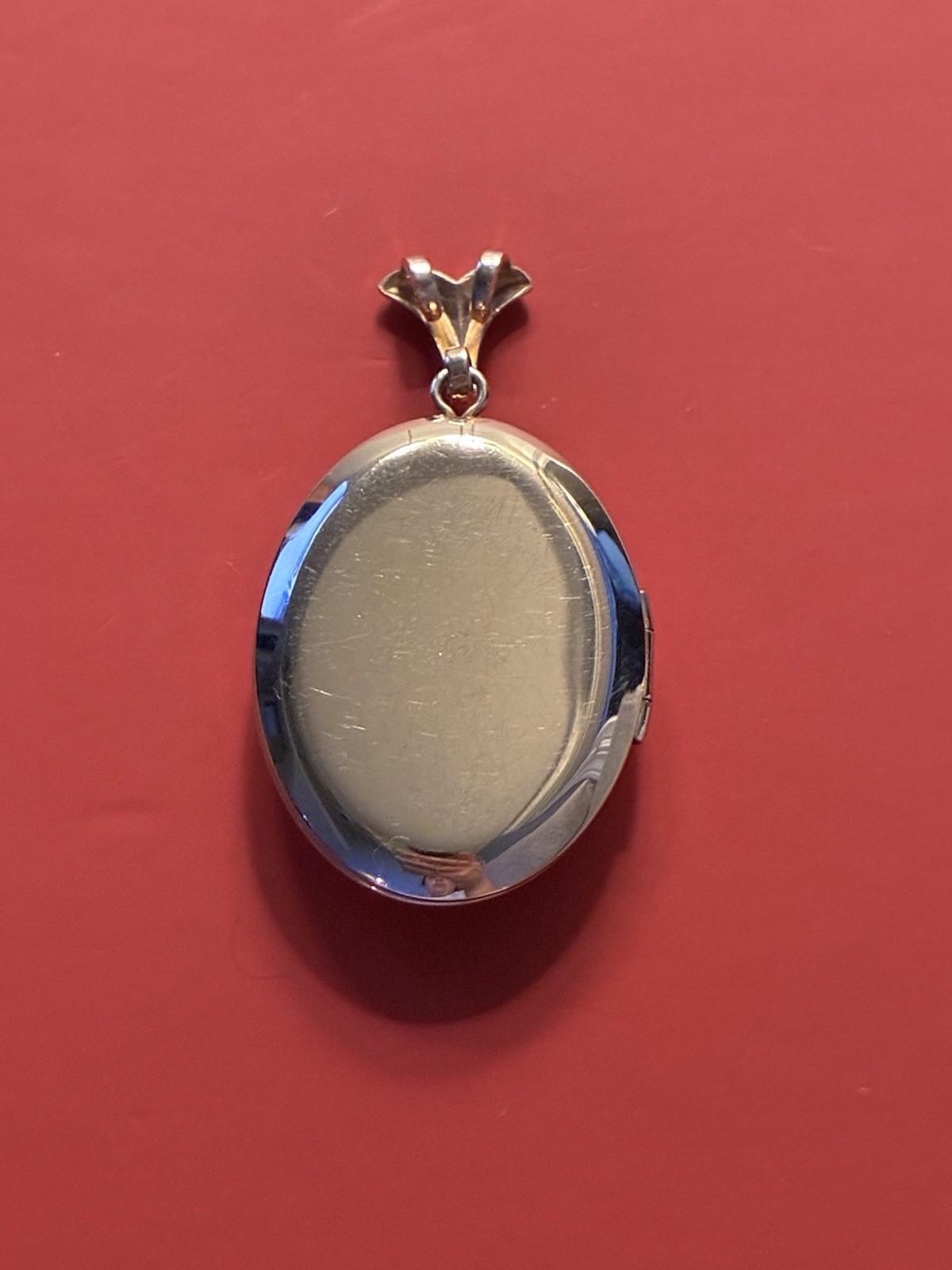 Gold filled locket with modern/geometric shapes and off-centre green cz stone