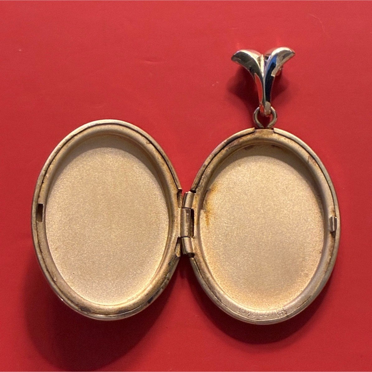 Gold filled locket with modern/geometric shapes and off-centre green cz stone