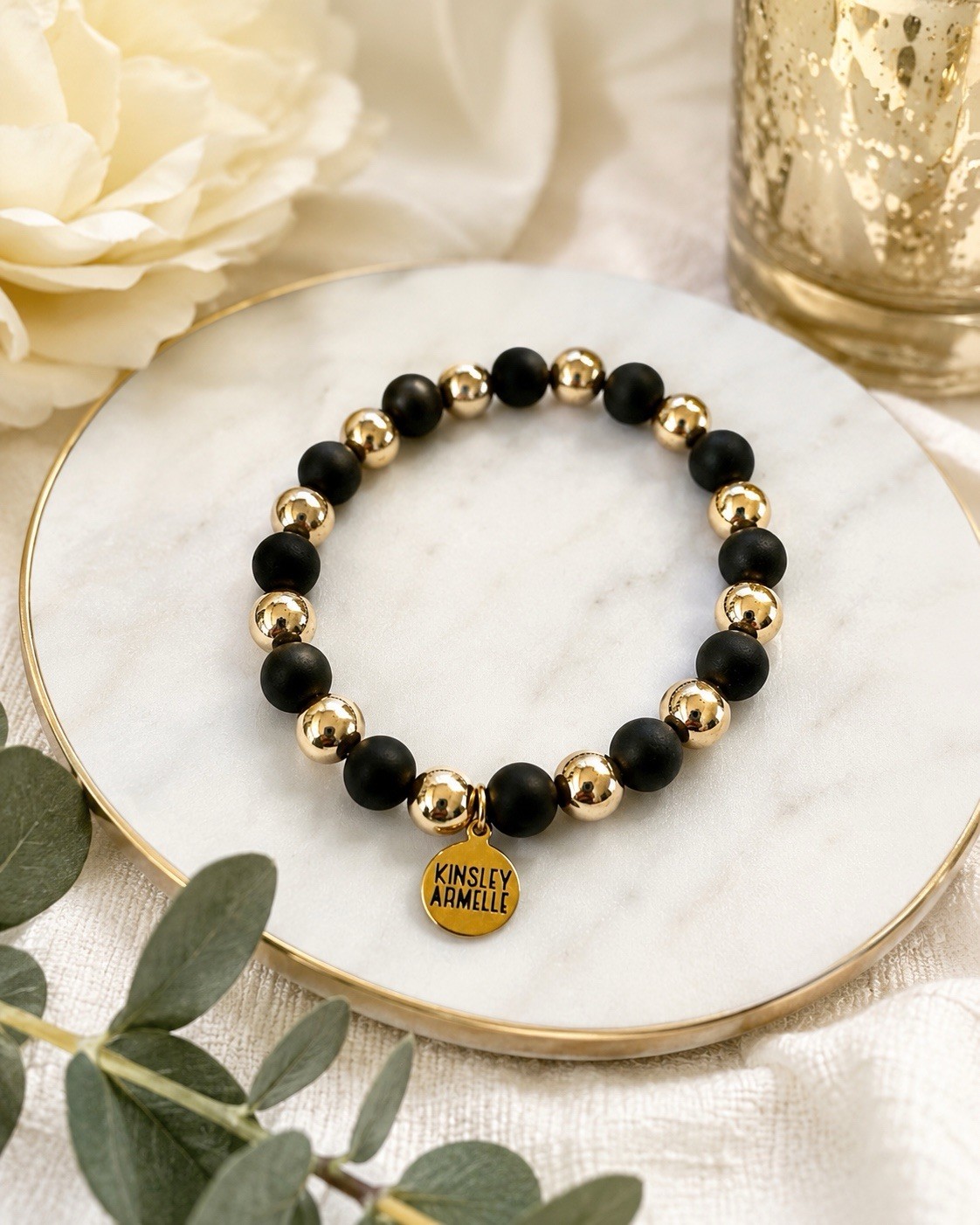 Kinsley Armelle Black Matte & Gold Beaded Stretch Bracelet Logo Charm