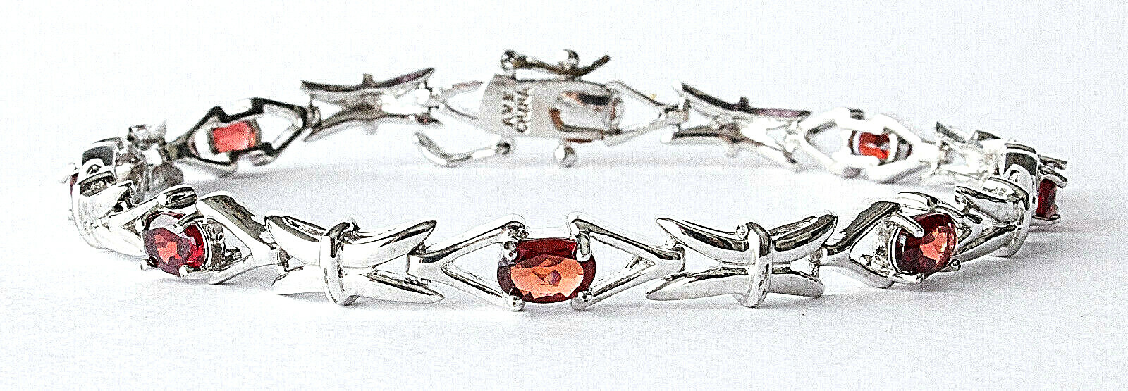SILVER PLATED OVER BRASS OVAL GARNET TENNIS BRACELET, 8″ LONG