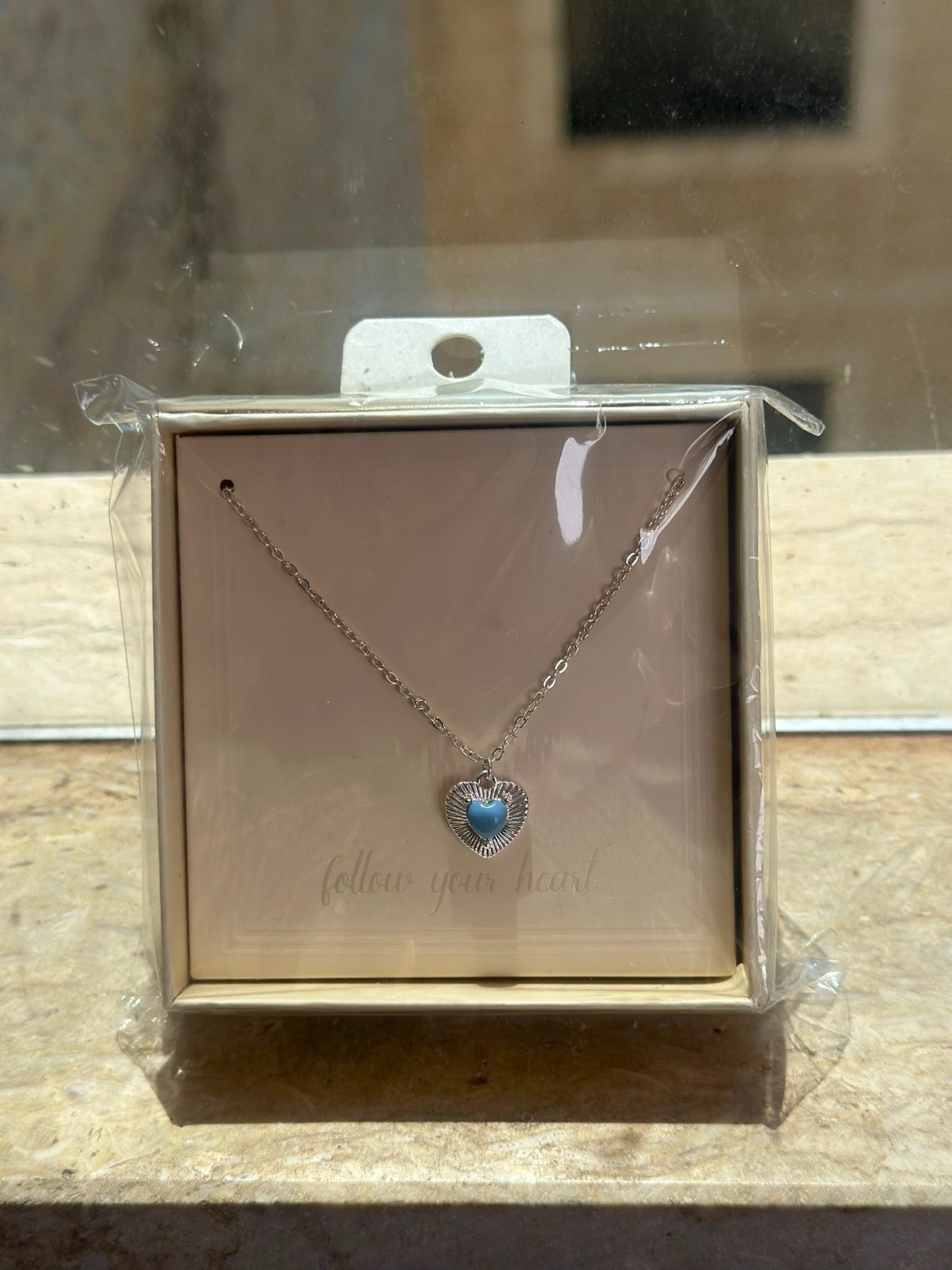 A smooth, rust-resistant silver chain featuring an elegant and attractive blue h