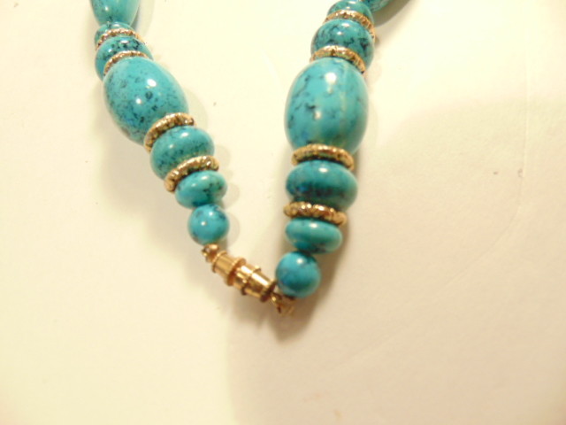 greenish blue beaded necklace with gold colored spacers – about 11 inches length