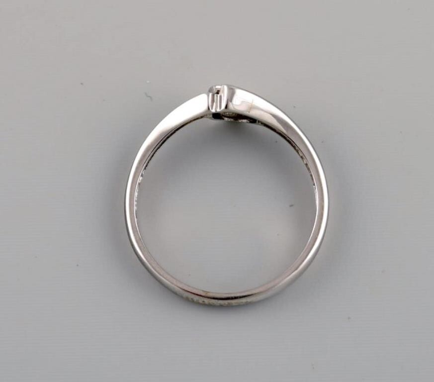Ring in 9 carat white gold adorned with cubic zirconia. 21st Century.