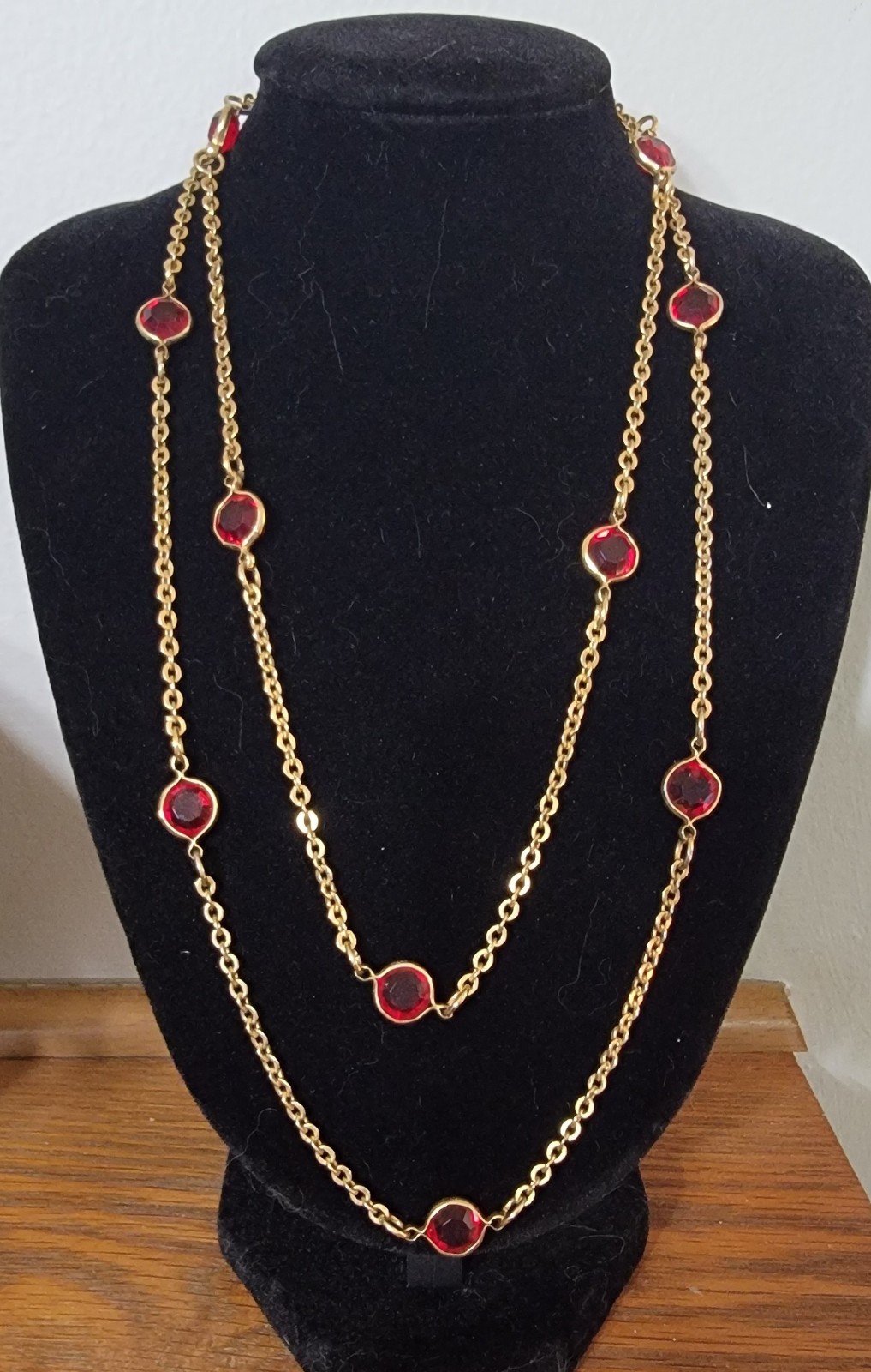 Vintage-style gold-tone station necklace with bezel-set round red crystals 34″