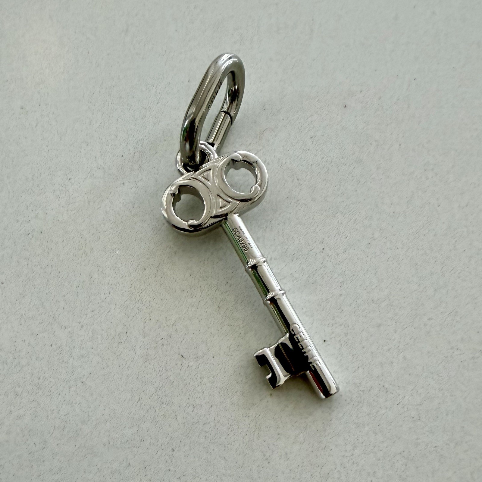 CELINE CHARM TRIOMPHE KEY IN BRASS WITH RHODIUM FINISH