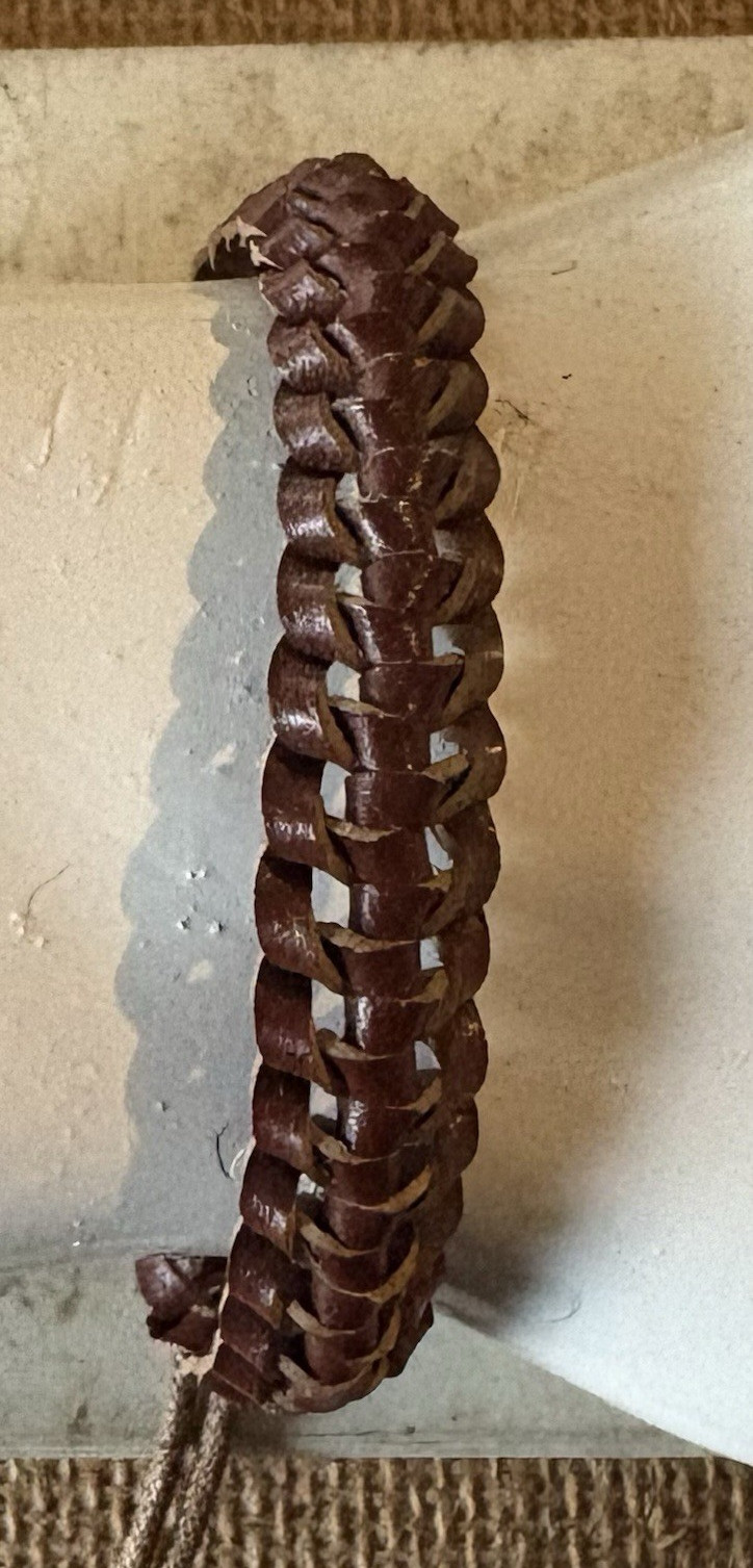 brown braided leather cord wrap bracelet . adjustable tie closure