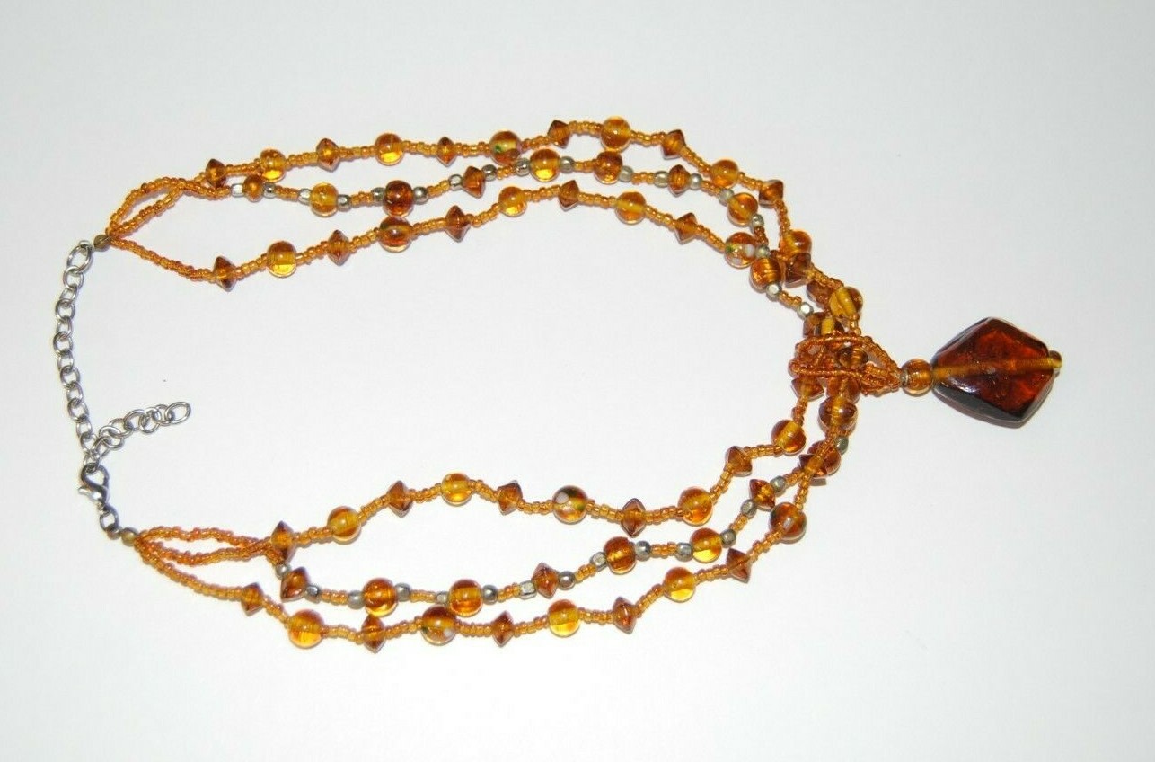 MULTI STRAND AMBER COLOR GLASS WITH LARGE GRIPOIX PENDANT STATEMENT NECKLACE