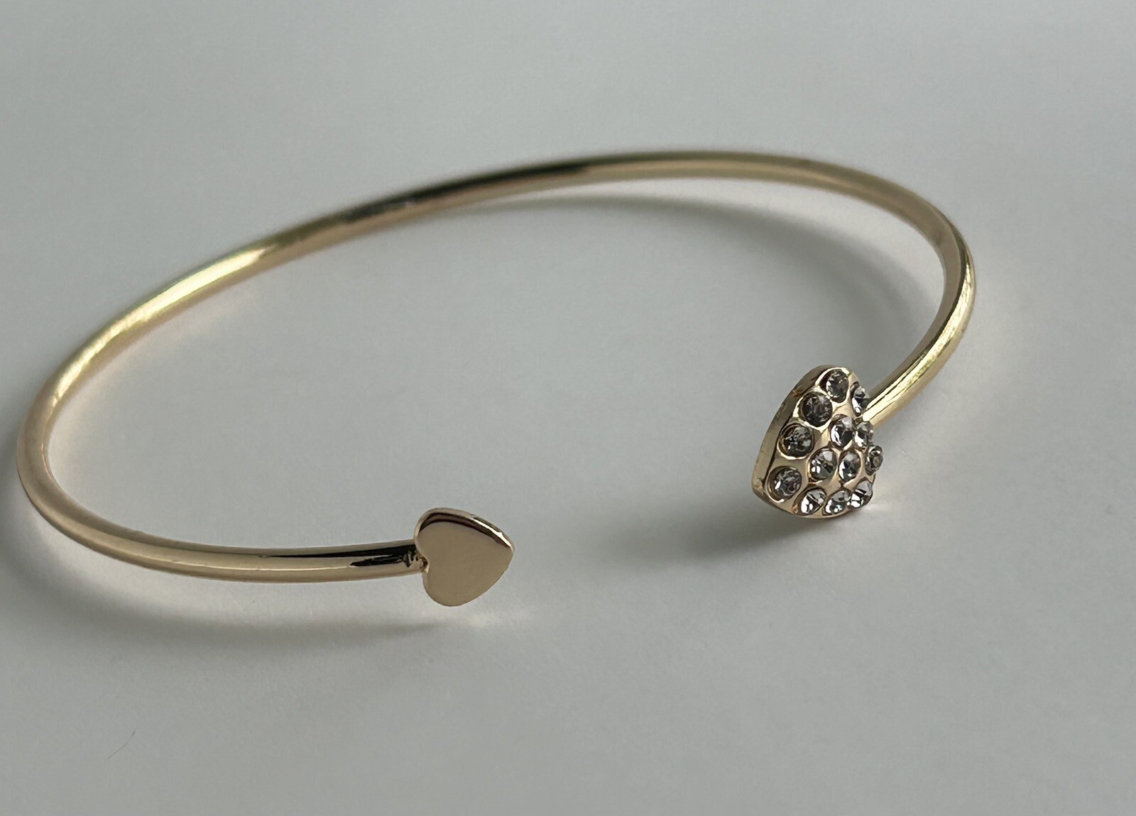 Gold Tone Open Cuff Bracelet (Bangle Style) with CZ Heart Ends