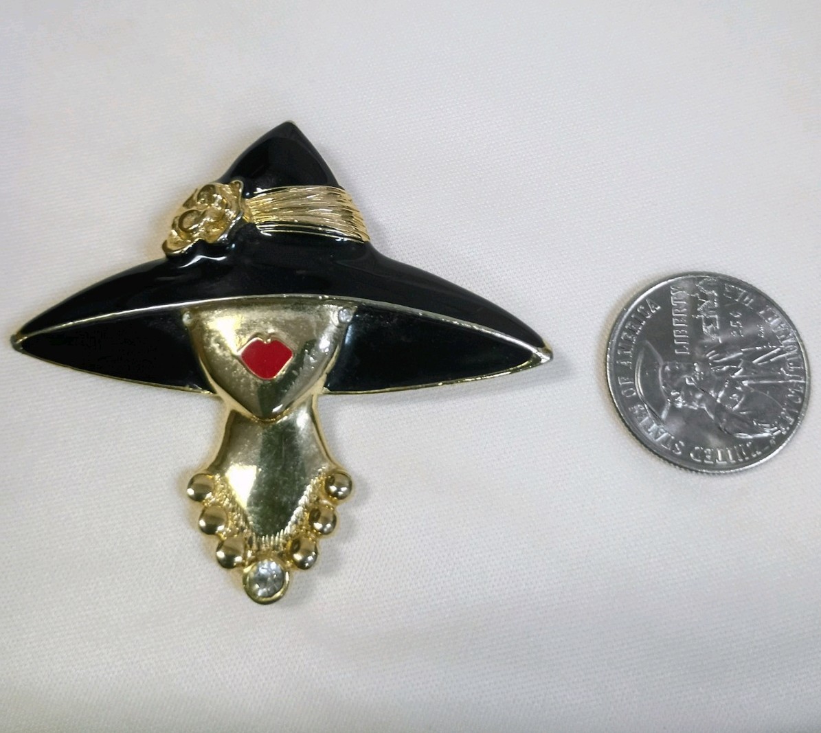 Vintage M J ENT gold-tone and black enamel lady hat brooch