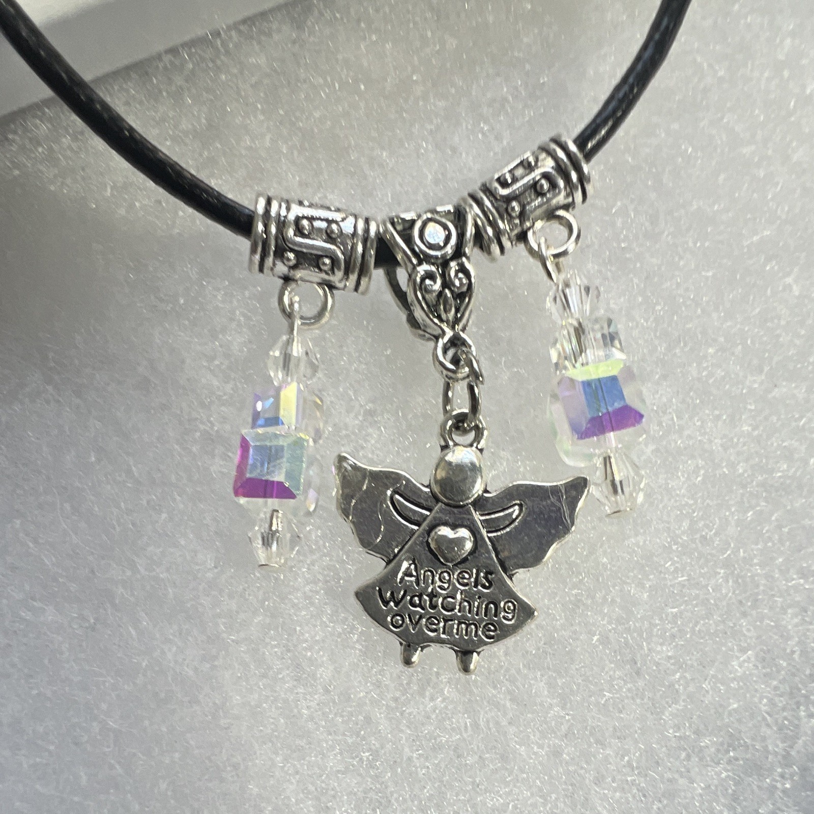 Angel pendant,inscribed, clear, crystal Aurora Borealis, leather lobster clasp.