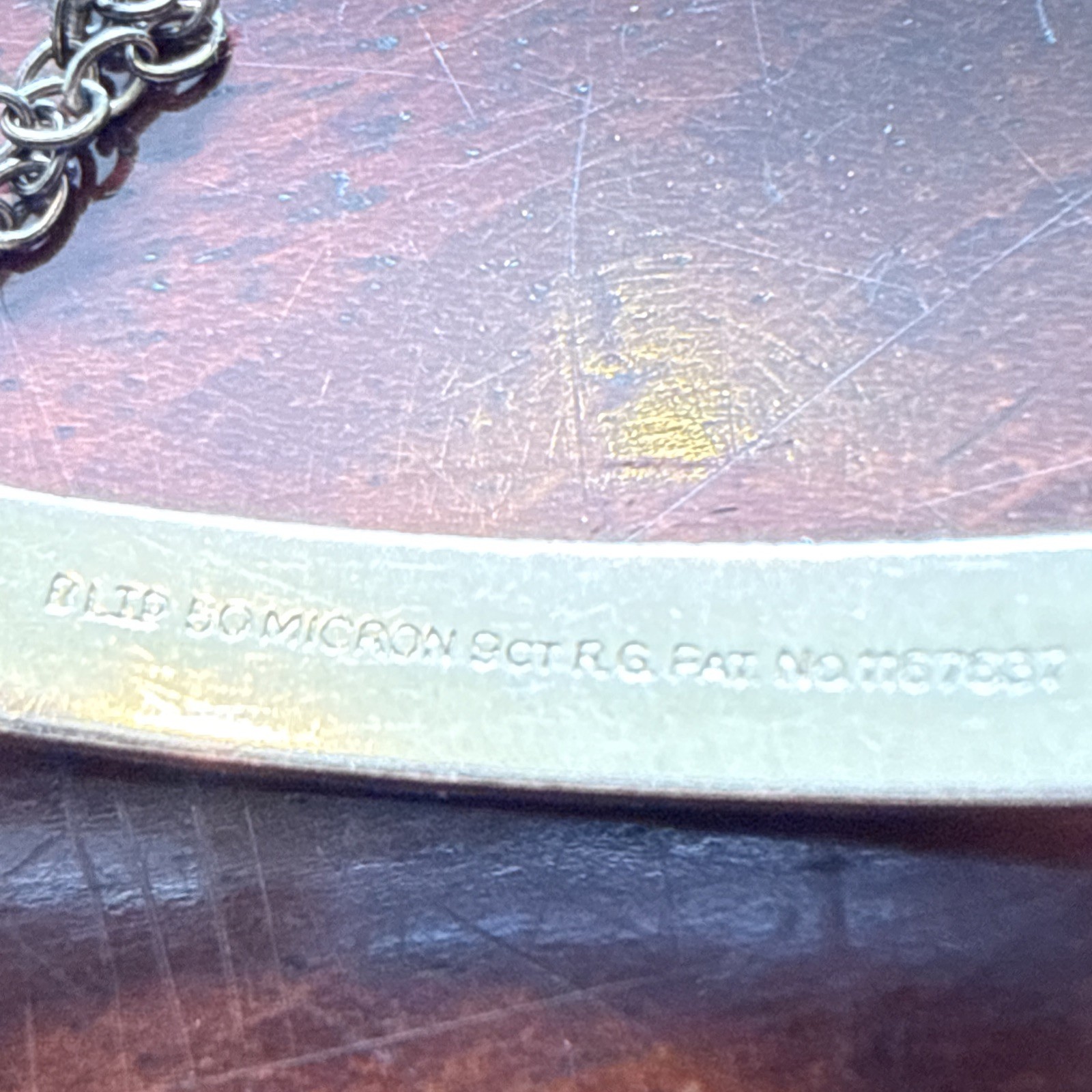 B Ltd 9ct 50 Micron Rolled Gold hinged engraved bangle with safety chain