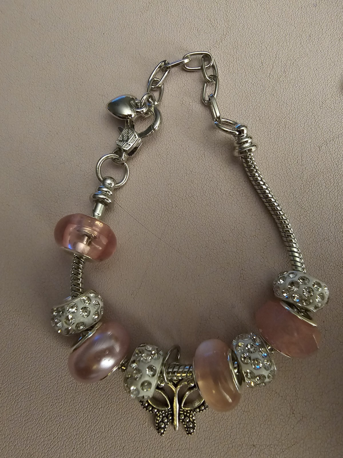 Homemade Pink and White Beaded Charm Bracelet With A Sliver Butterfly Charm