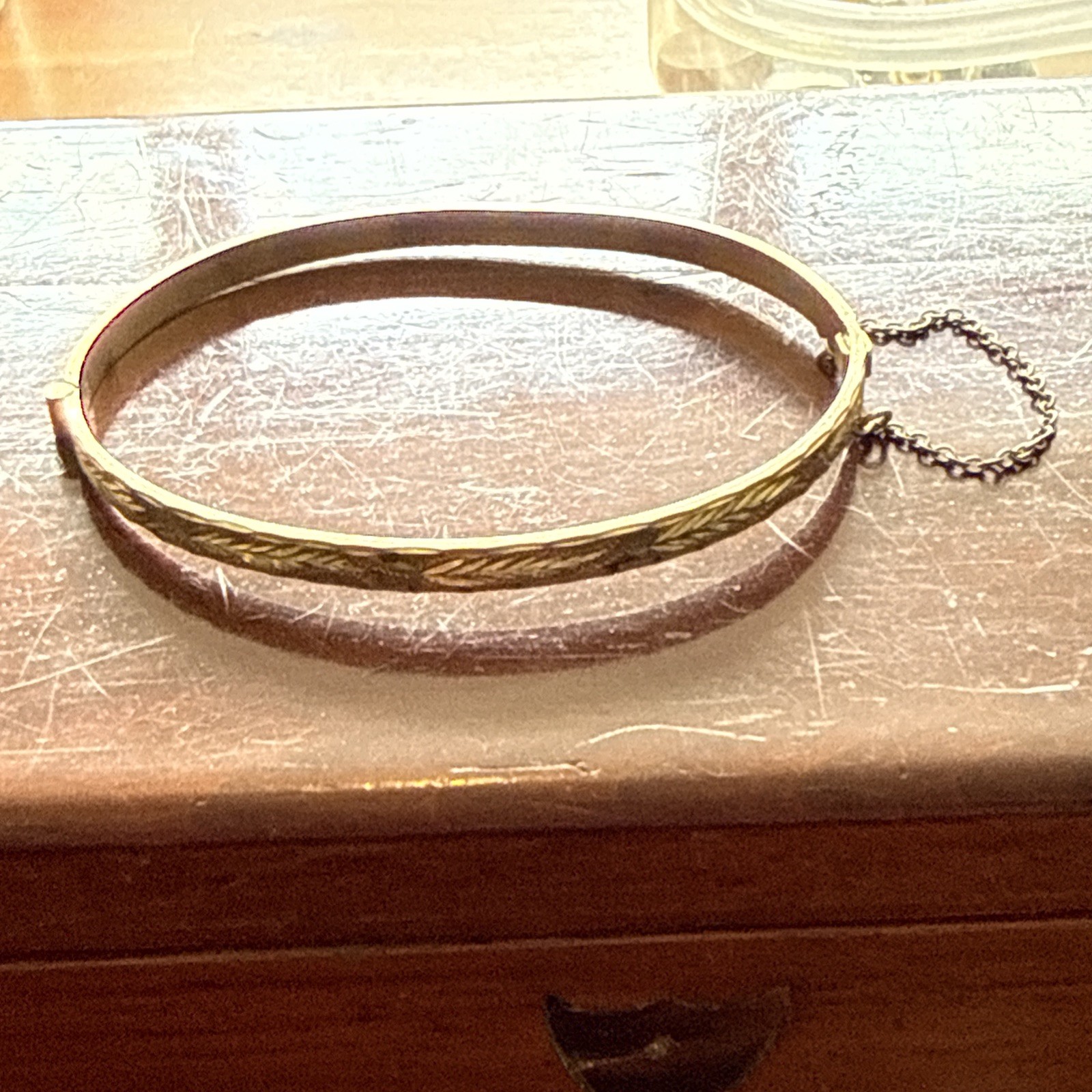 B Ltd 9ct 50 Micron Rolled Gold hinged engraved bangle with safety chain