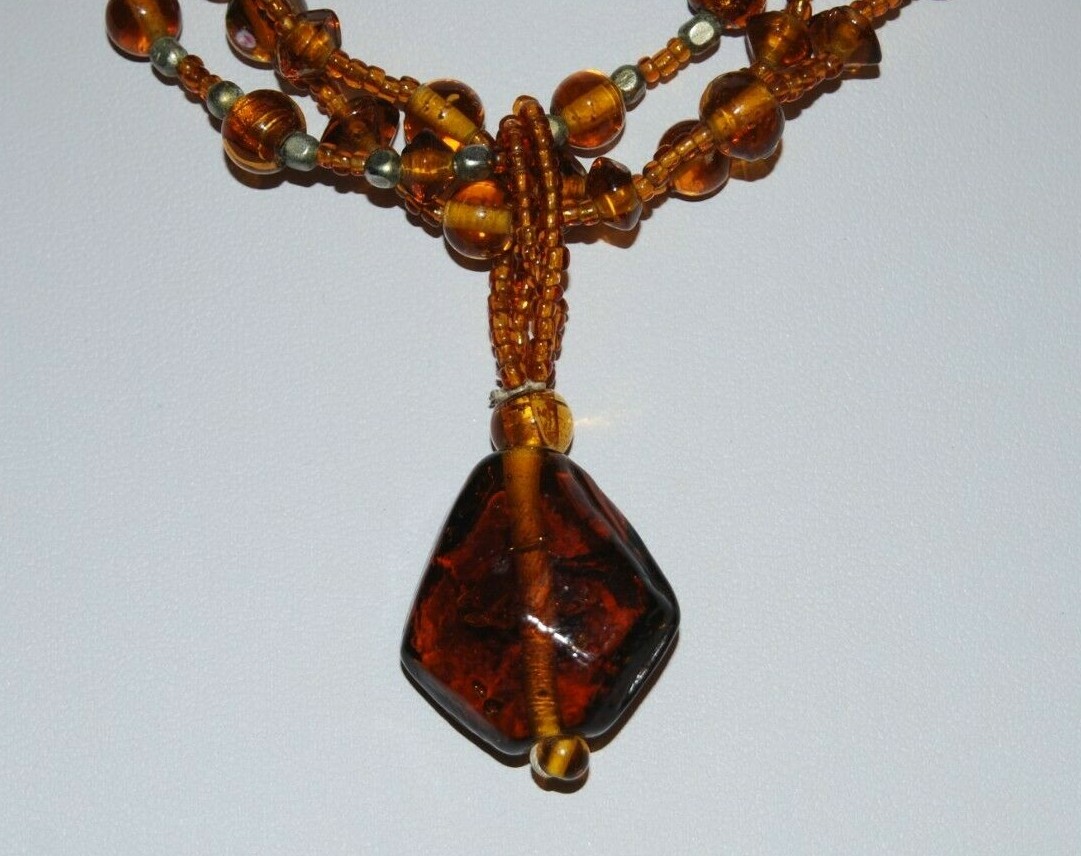 MULTI STRAND AMBER COLOR GLASS WITH LARGE GRIPOIX PENDANT STATEMENT NECKLACE