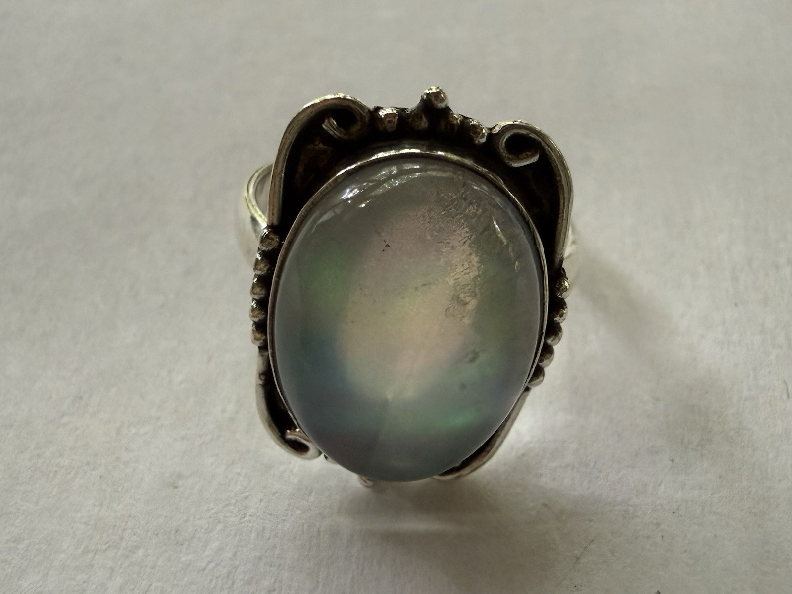 Elegant size 10 silver plated statement ring featuring an iridescent Opalite.