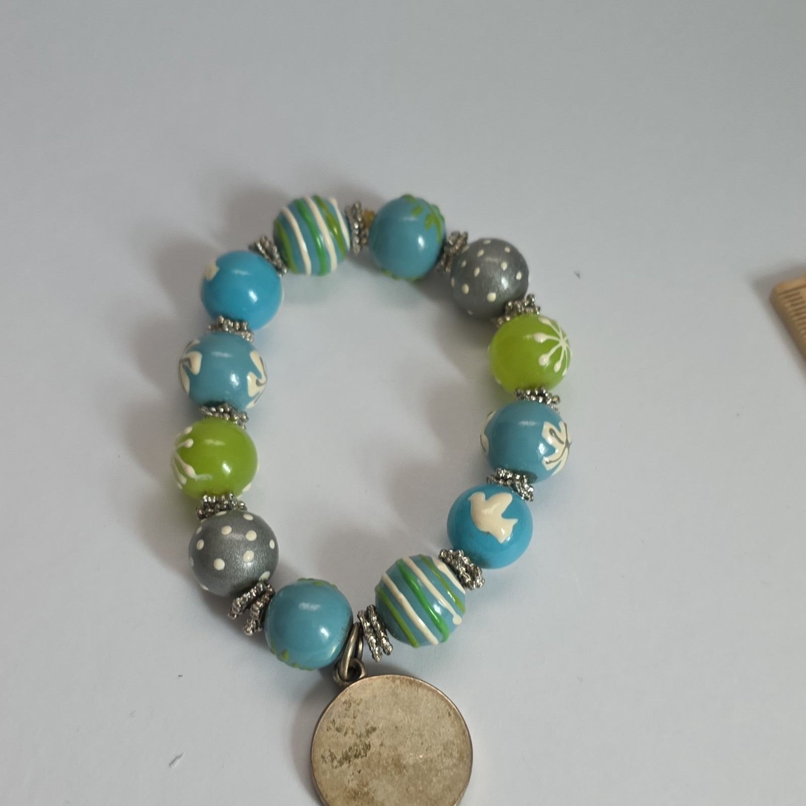 Vintage Angela Moore hand-painted beaded bracelet features blue, green, & gray