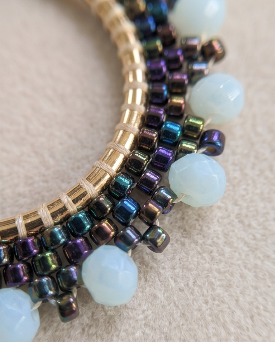 Hoop circle earrings with black peacock seed beads and blue beads