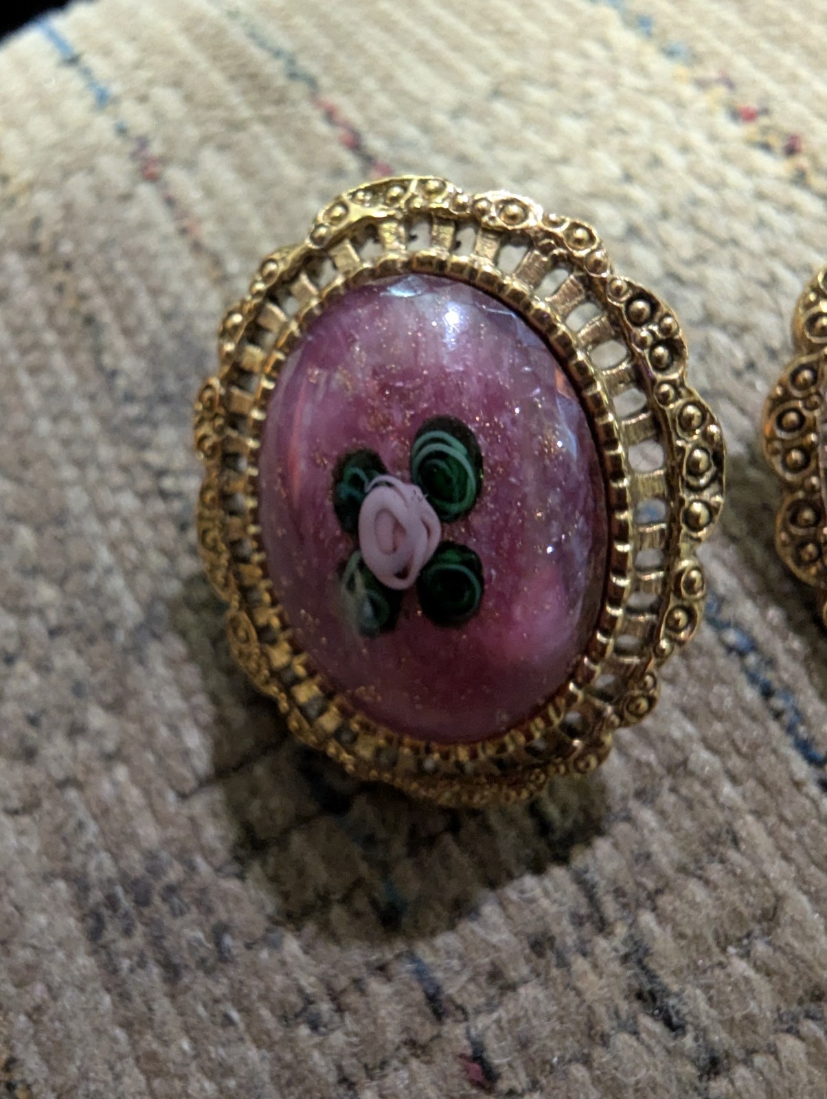 Gold Colored Filigree Earrings With Flower And Leaves Surrounded By Purple